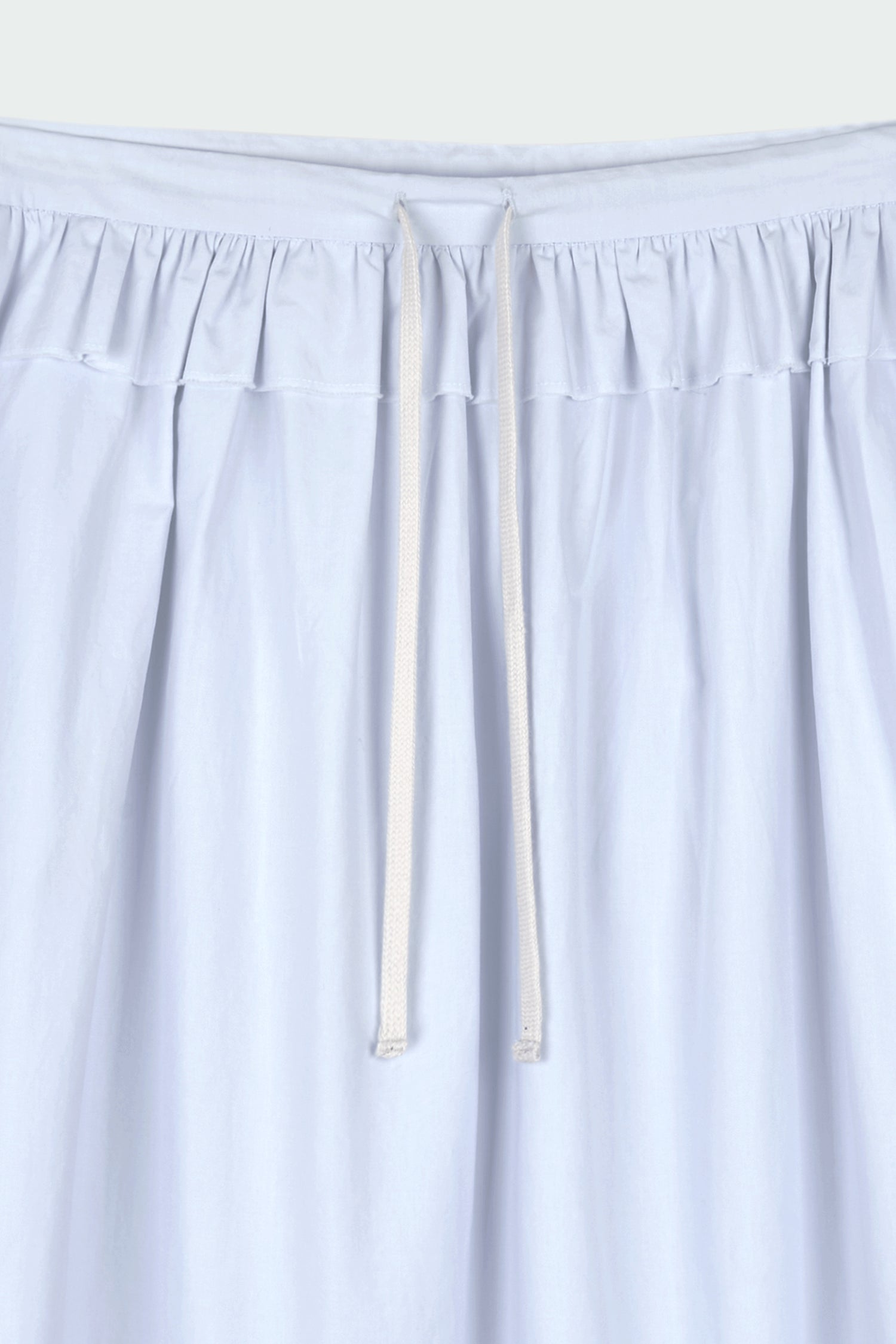 Maryam Skirt in sky, a midi cotton skirt with shirred waistband, drawstring detail, side pockets, and a softly flared silhouette