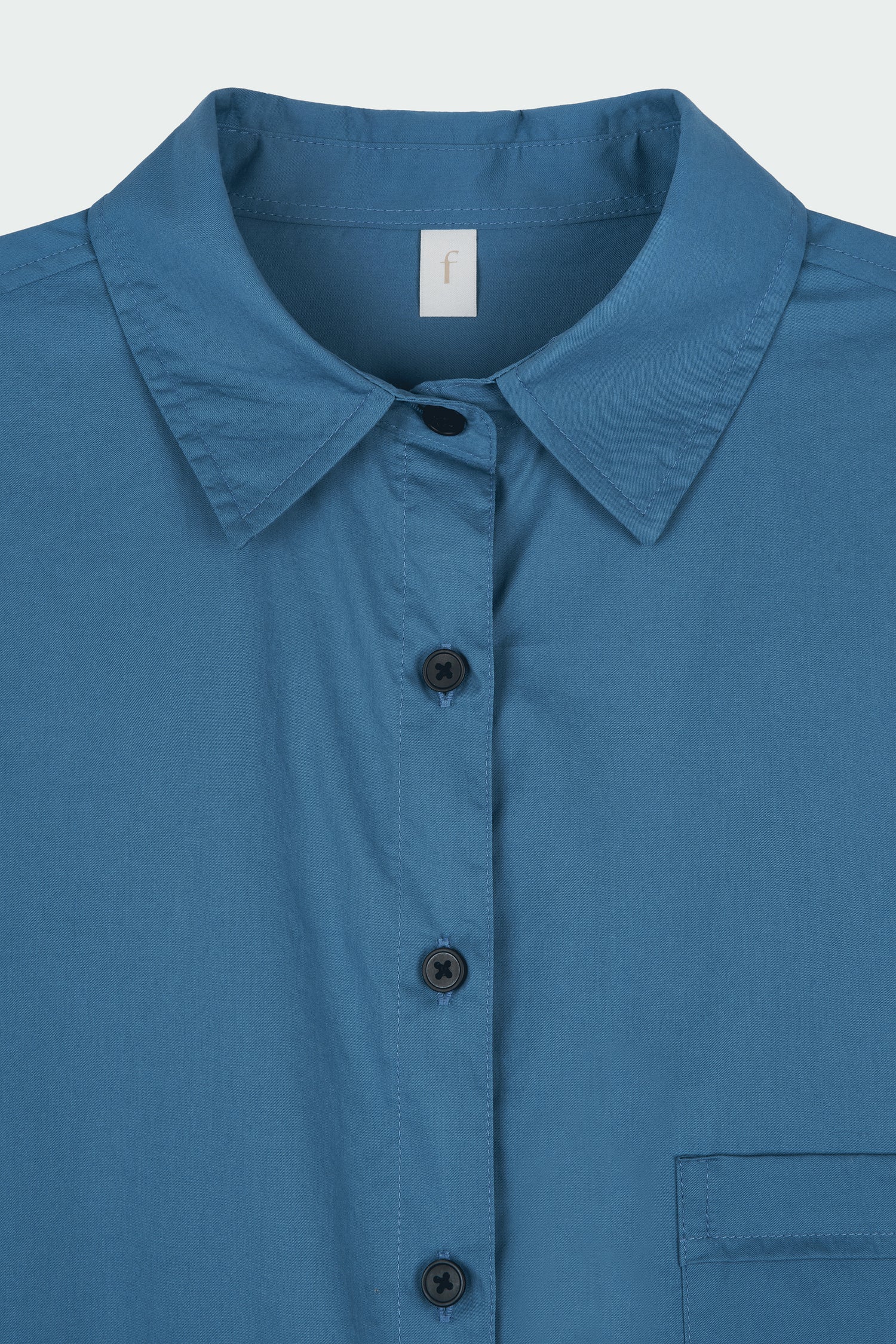 Cara Dress in blue green, long sleeve cotton shirt dress with front chest pocket, curved hem, hidden side pockets, and a relaxed silhouette.