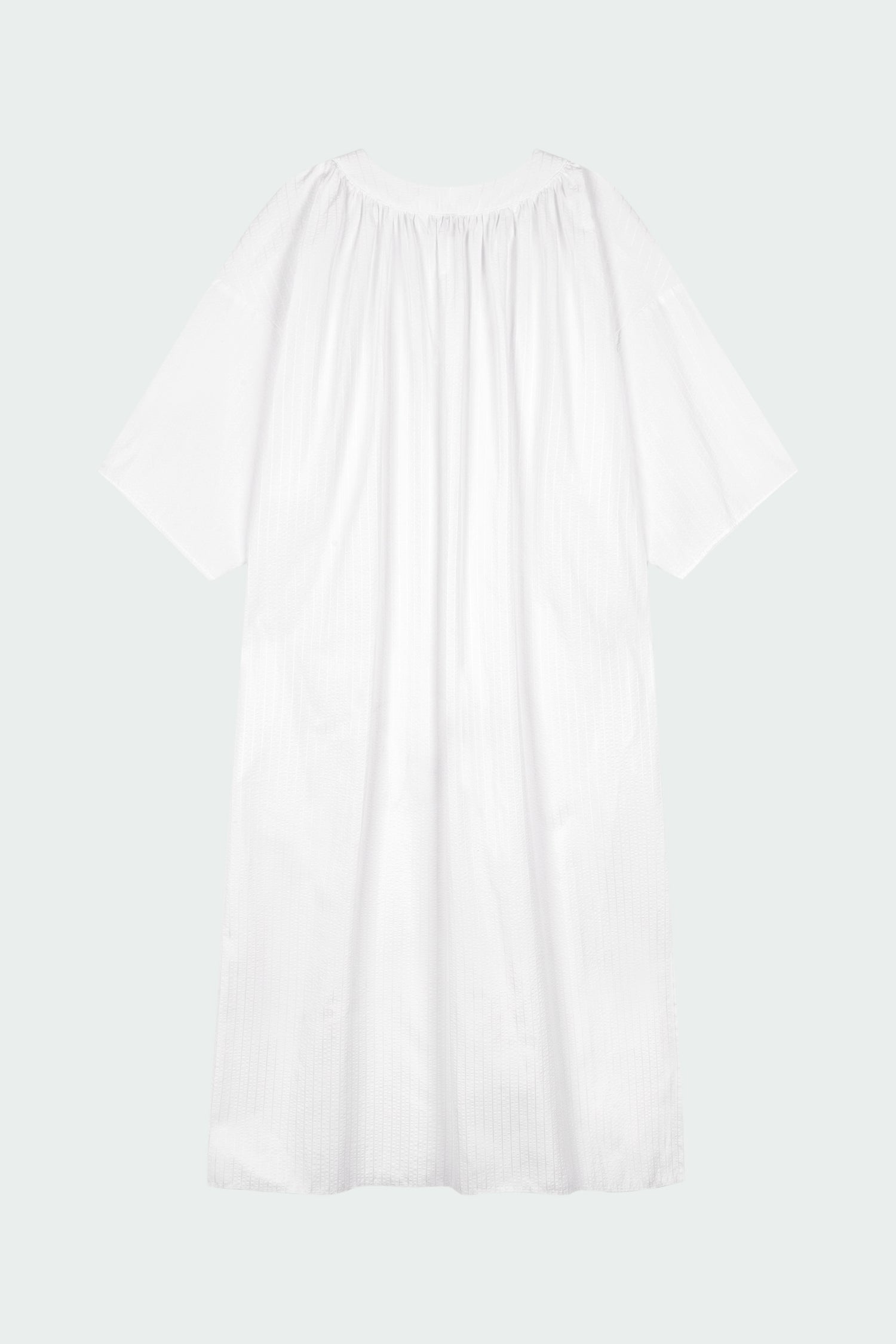 Charlotte Dress in white stripe, V-neck summer maxi dress in a lightweight linen-rayon blend with drop shoulders, hidden side pockets, raw edge hem, and a relaxed fit.
