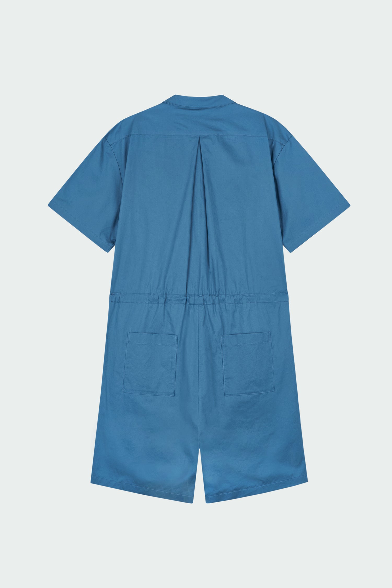 Emma Jumpsuit in blue green, short-sleeve cotton jumpsuit with camp collar, front buttons, drawstring waist, and multiple pockets.