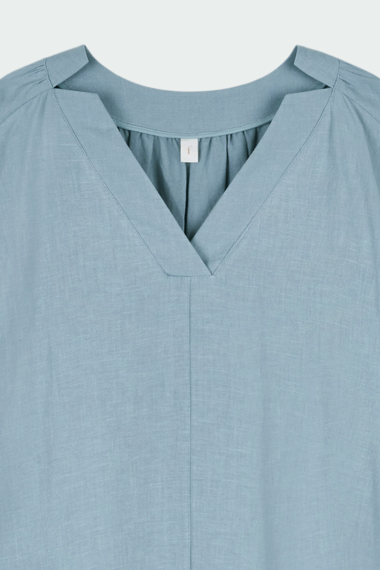 Charlotte Dress in light blue, V-neck summer maxi dress in a lightweight linen-rayon blend with drop shoulders, hidden side pockets, raw edge hem, and a relaxed fit.