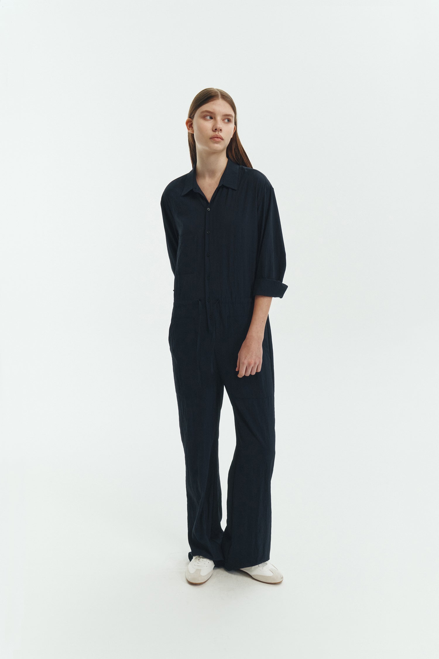 Saige Jumpsuit in navy, long-sleeve rayon blend jumpsuit with point collar, front button closure, drawstring waist, and patch pockets