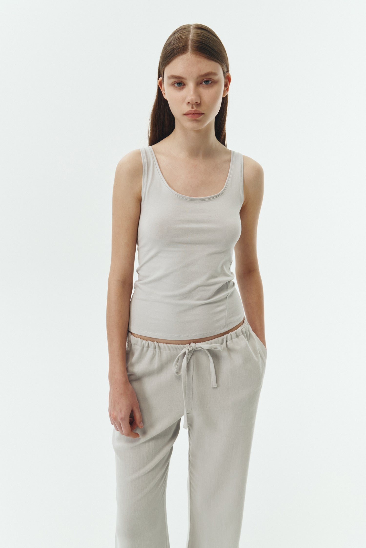 Zoe Tank Top in cloud gray, slim-fit stretch cotton tank with scooped neckline and diagonal seam detail for a sleek and minimal silhouette.