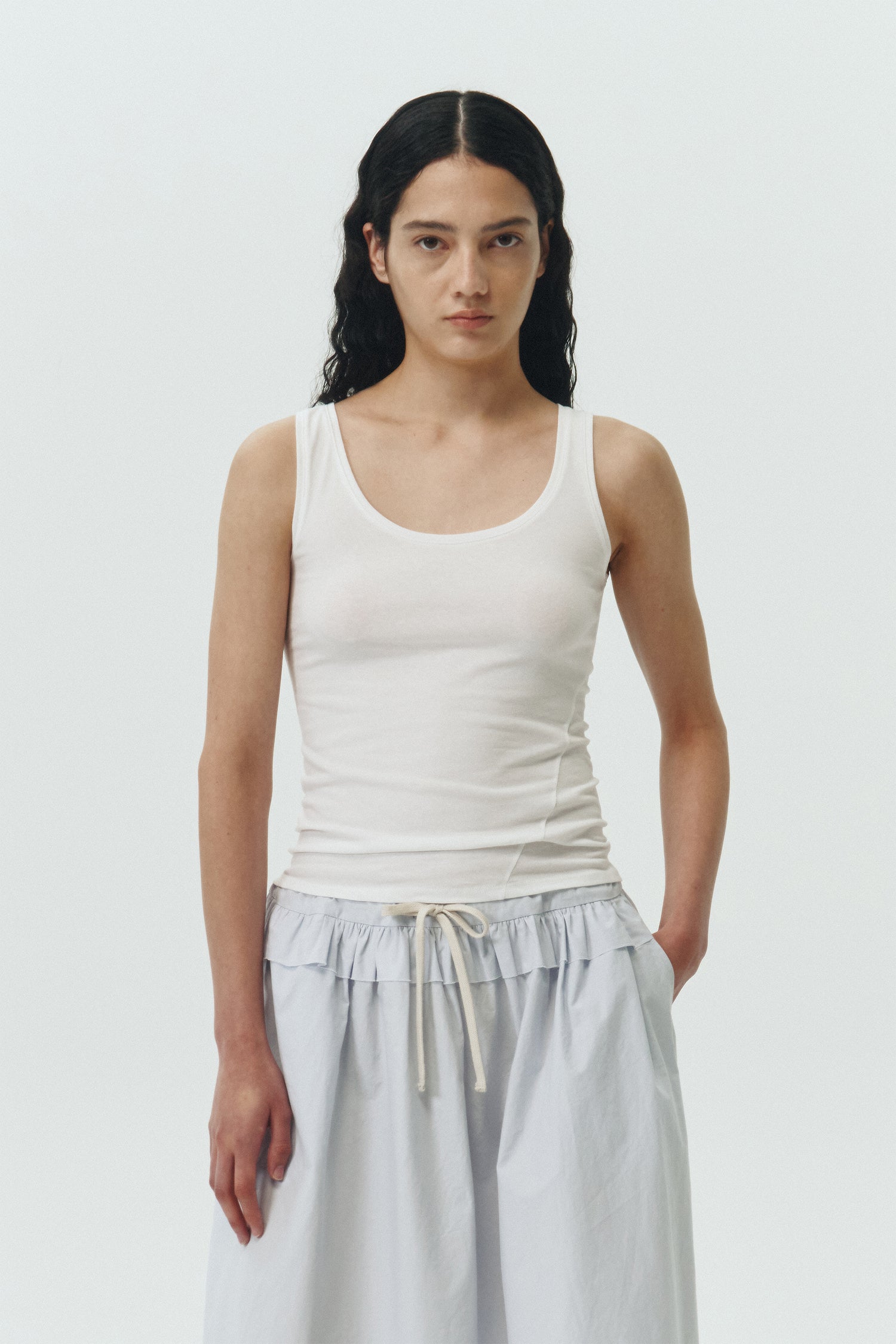 Zoe Tank Top in white, slim-fit stretch cotton tank with scooped neckline and diagonal seam detail for a sleek and minimal silhouette.