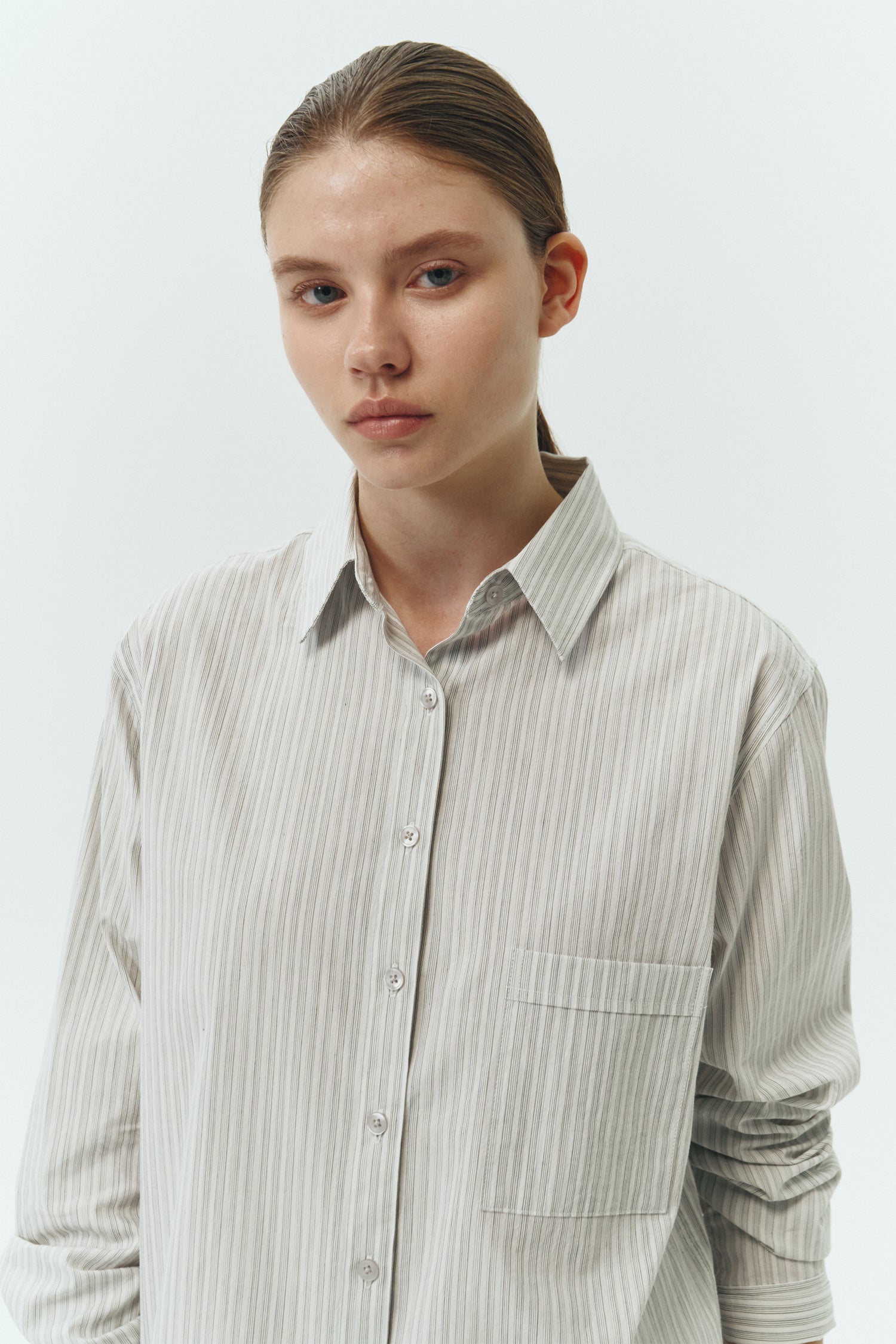 Isabella Shirt in stripe, a lightweight cotton-poly blend button-up with chest pocket, back pleat, and buttoned cuffs, designed in a regular fit with a hip-length silhouette