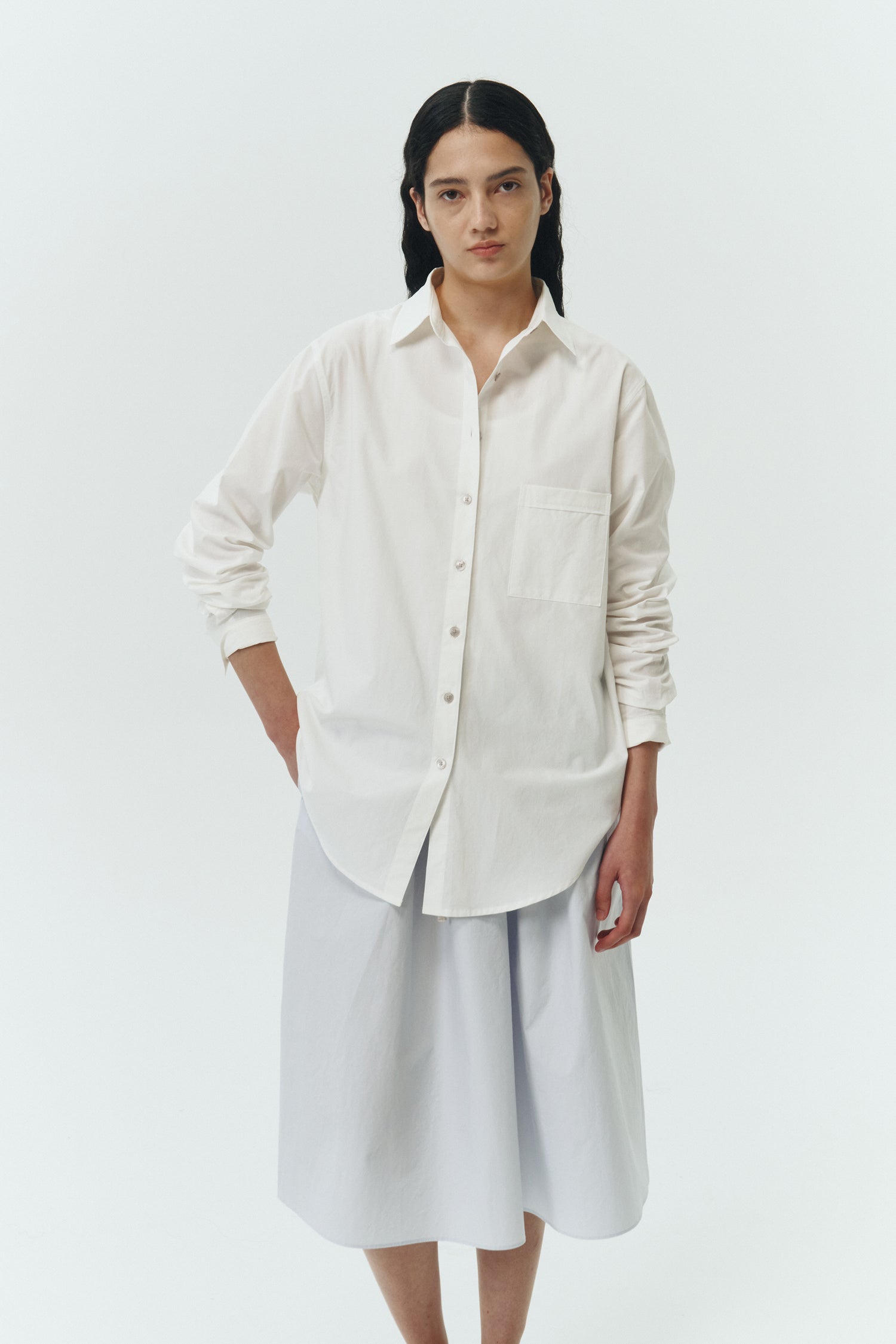 Maryam Skirt in sky, a midi cotton skirt with shirred waistband, drawstring detail, side pockets, and a softly flared silhouette