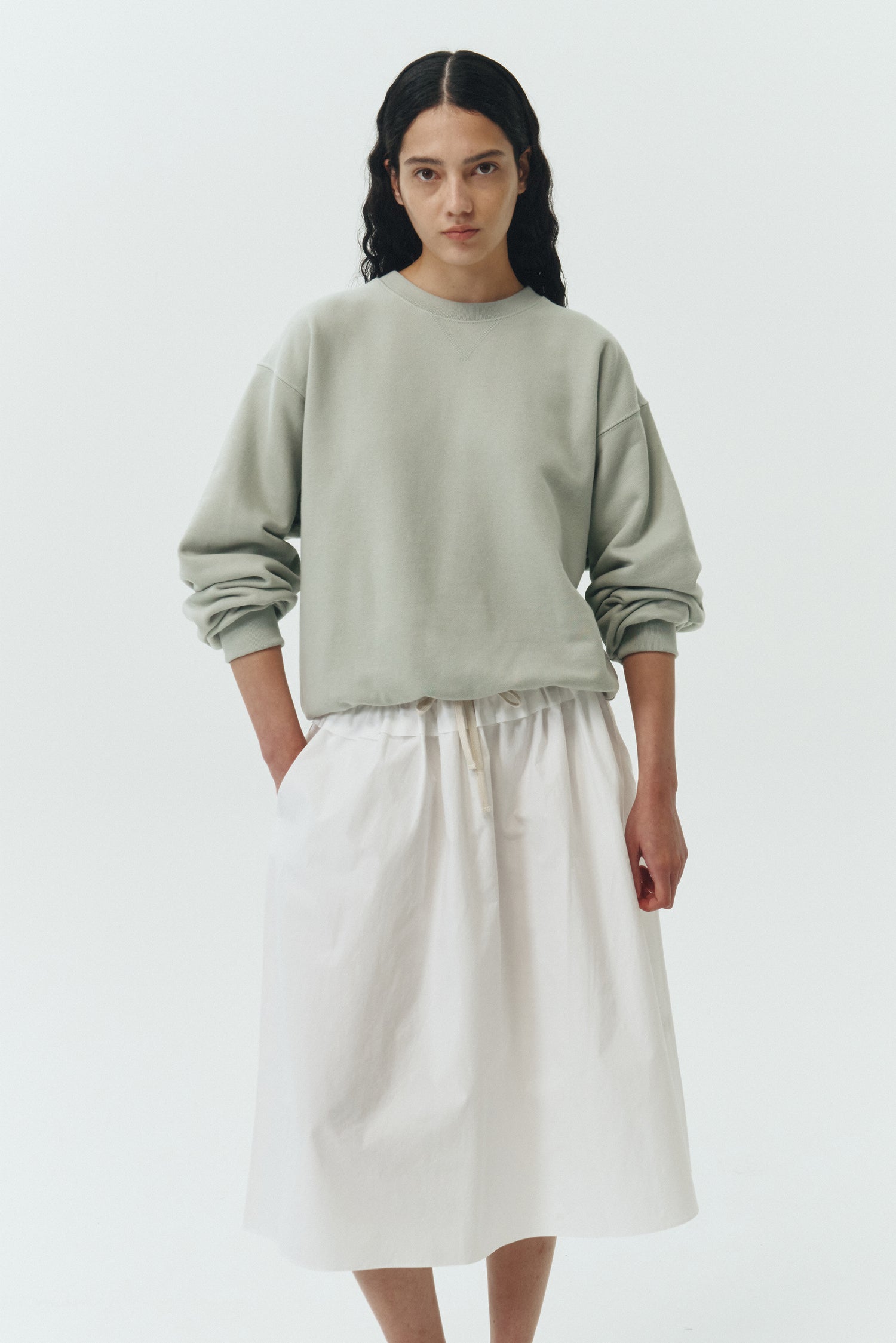 Maryam Skirt in sky, a midi cotton skirt with shirred waistband, drawstring detail, side pockets, and a softly flared silhouette