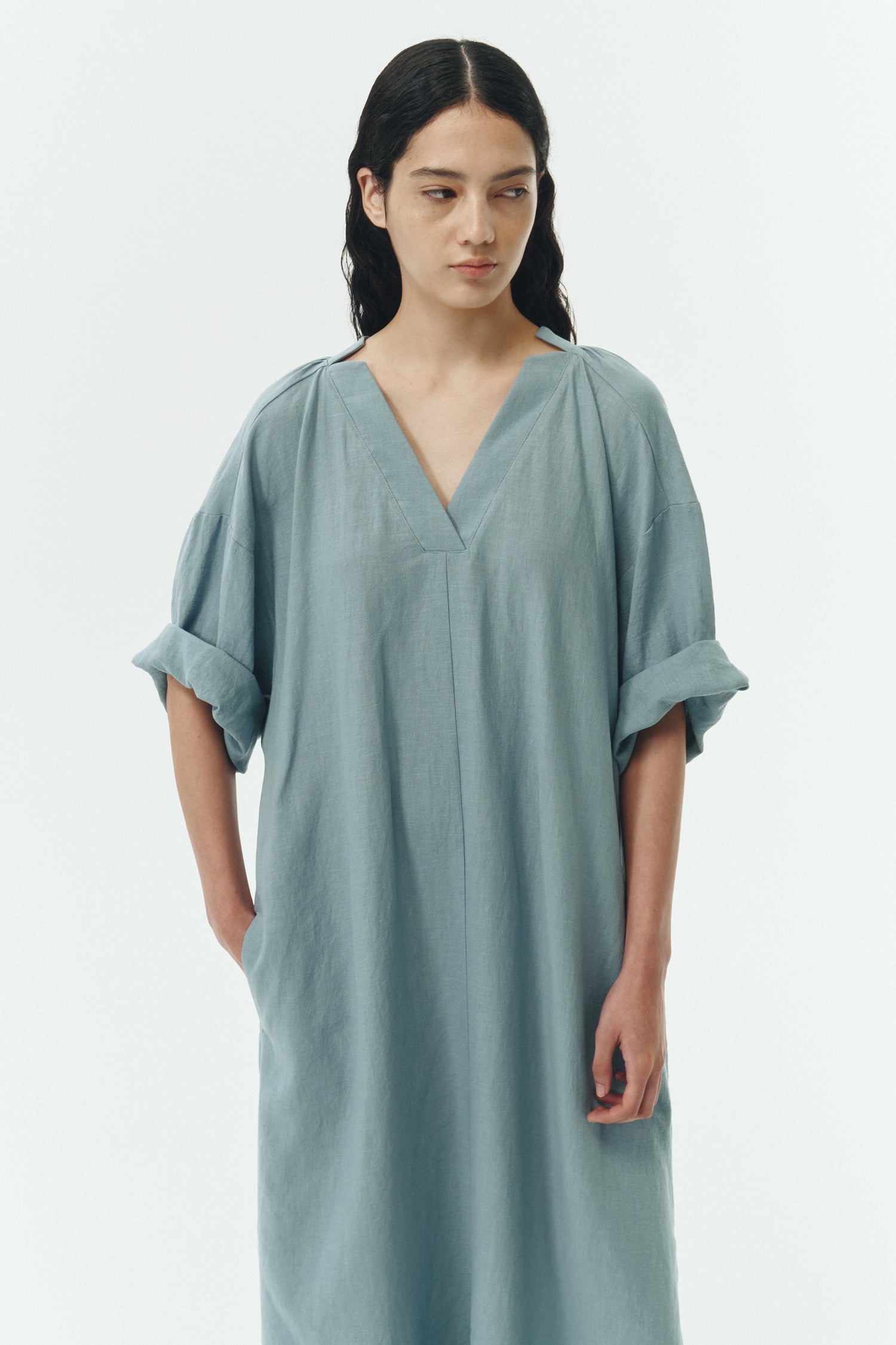 Charlotte Dress in light blue, V-neck summer maxi dress in a lightweight linen-rayon blend with drop shoulders, hidden side pockets, raw edge hem, and a relaxed fit.