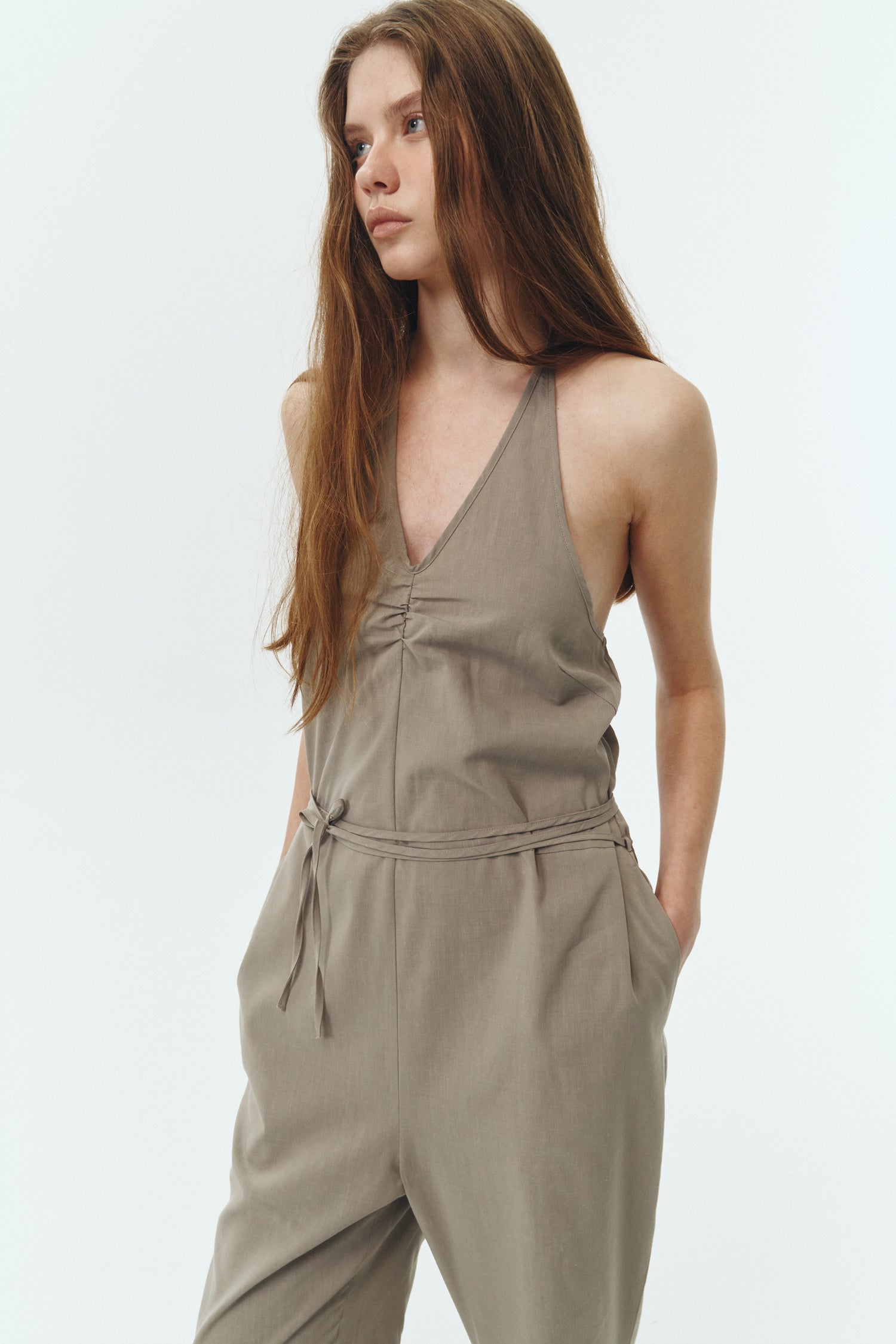 Daisy Jumpsuit in khaki gray, sleeveless linen blend jumpsuit with adjustable halterneck, open back, straight-leg silhouette, and relaxed fit.