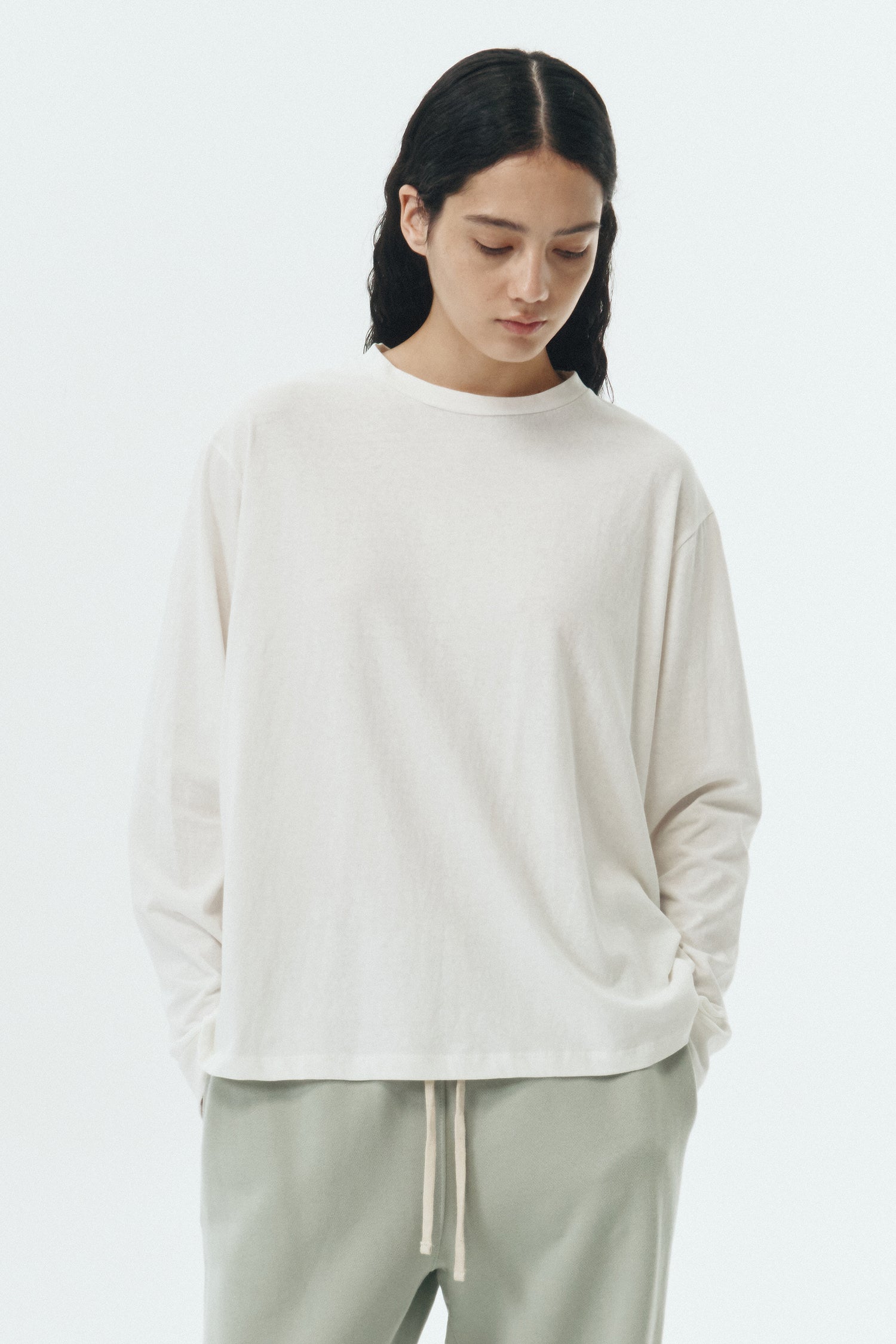 Lara Long-Sleeved T-Shirt in washed white, a lightweight cotton crew-neck tee with long sleeves and relaxed fit, ideal for everyday wear and seasonal layering