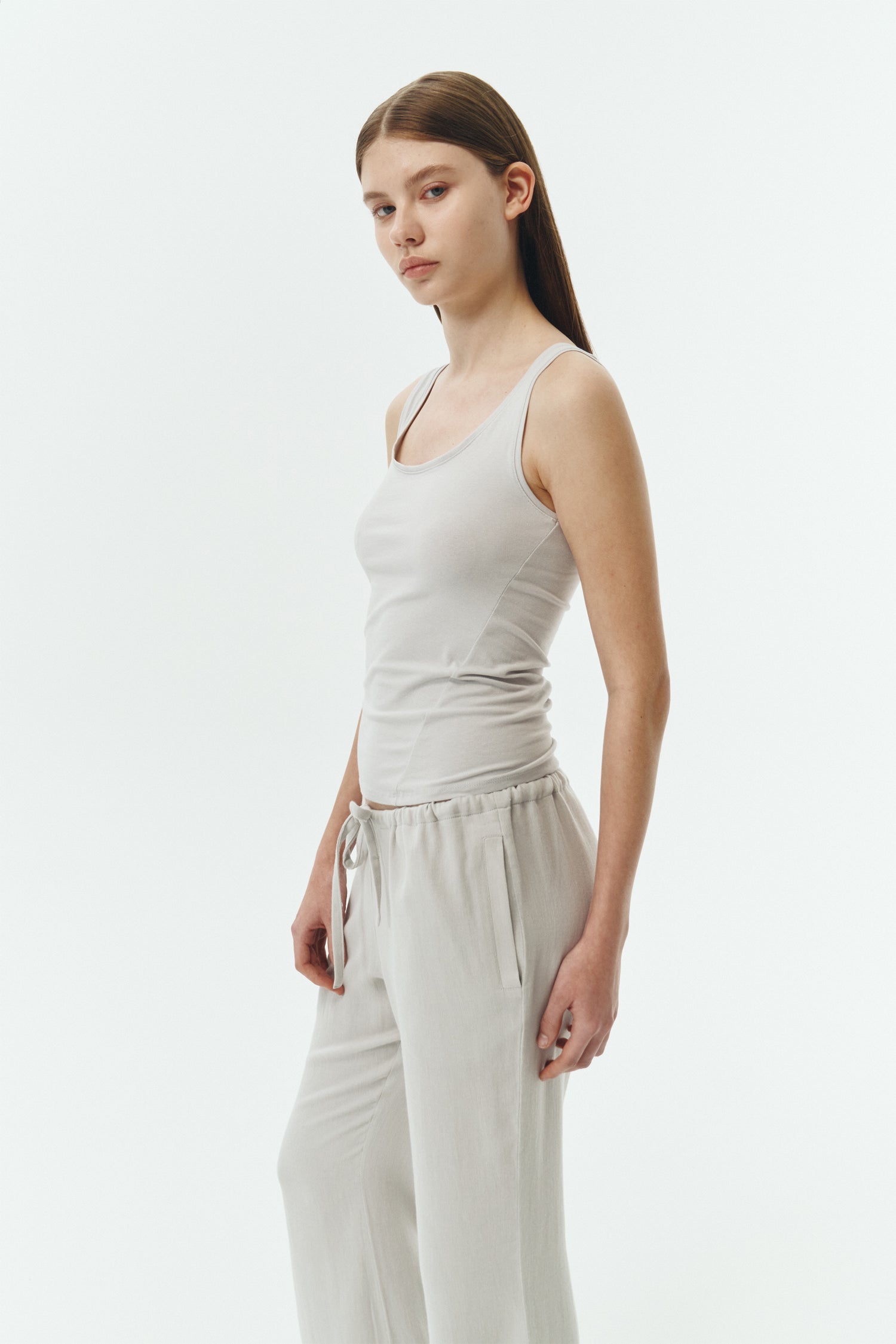 Zoe Tank Top in cloud gray, slim-fit stretch cotton tank with scooped neckline and diagonal seam detail for a sleek and minimal silhouette.
