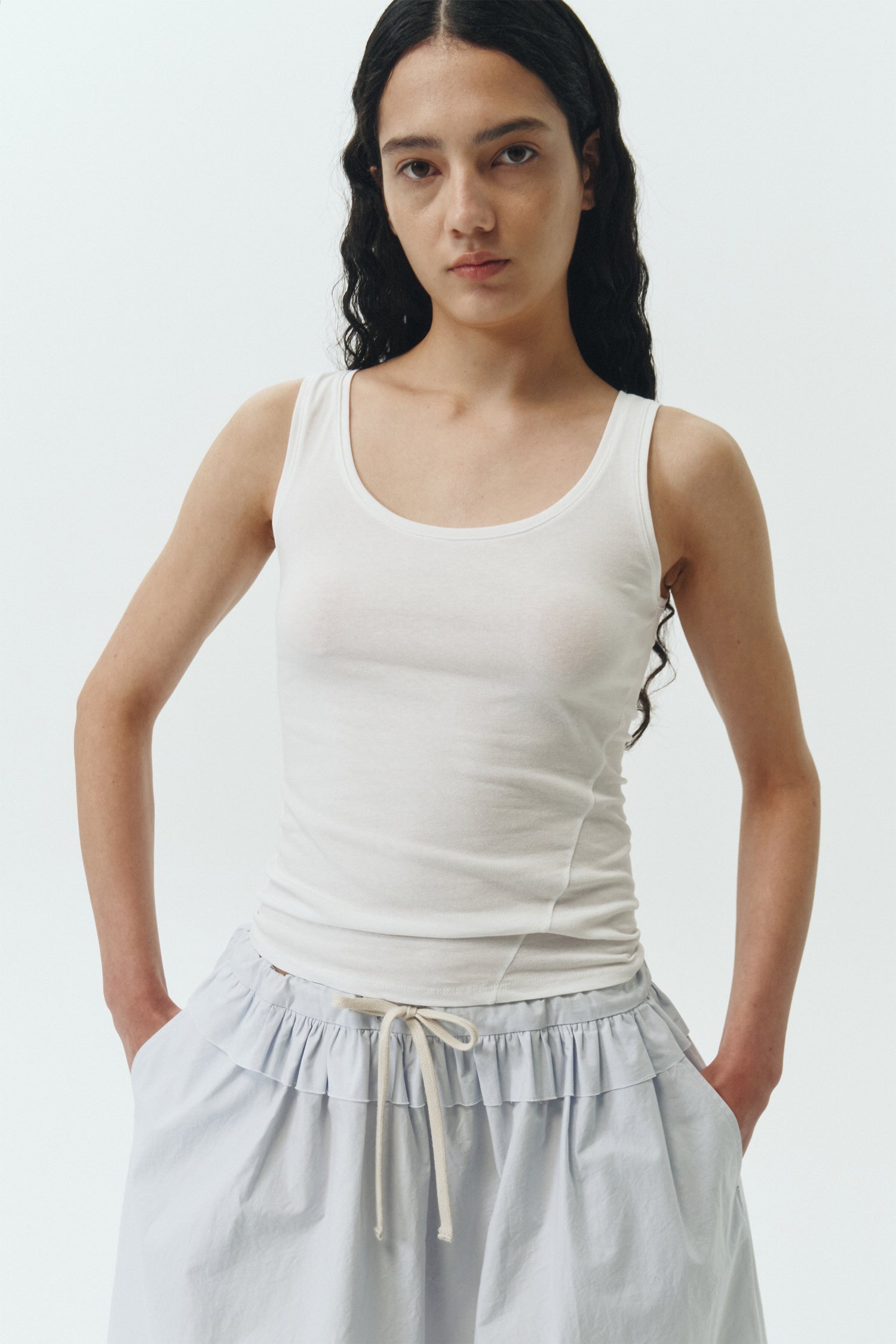 Zoe Tank Top in white, slim-fit stretch cotton tank with scooped neckline and diagonal seam detail for a sleek and minimal silhouette.
