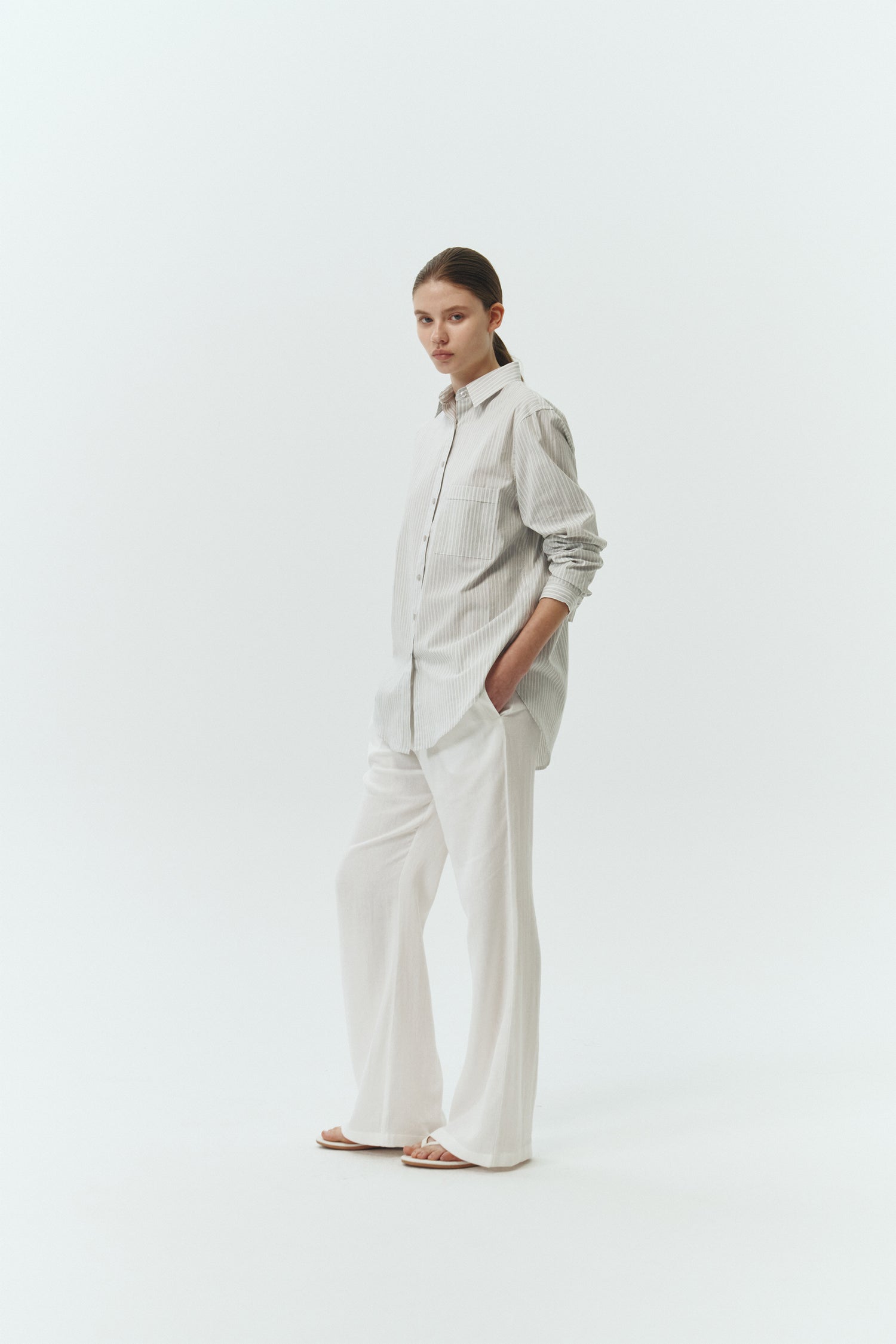 Isabella Shirt in stripe, a lightweight cotton-poly blend button-up with chest pocket, back pleat, and buttoned cuffs, designed in a regular fit with a hip-length silhouette
