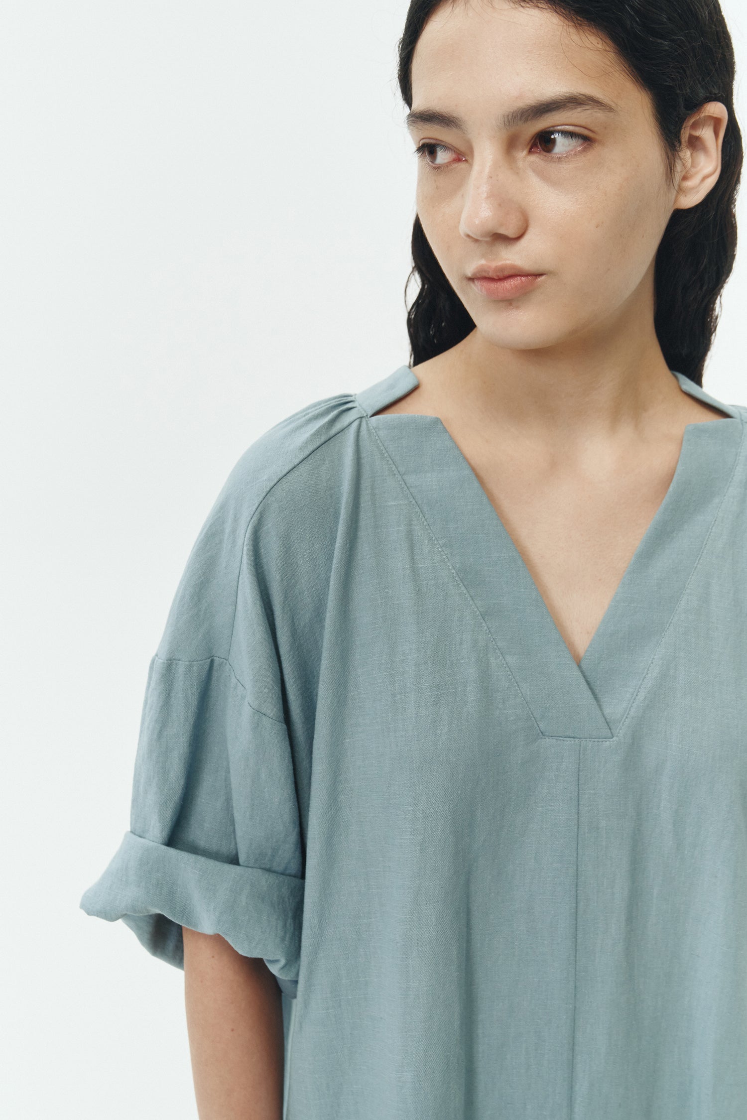 Charlotte Dress in light blue, V-neck summer maxi dress in a lightweight linen-rayon blend with drop shoulders, hidden side pockets, raw edge hem, and a relaxed fit.