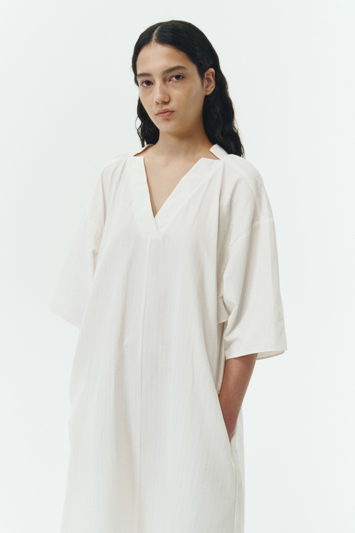 Charlotte Dress in white stripe, V-neck summer maxi dress in a lightweight linen-rayon blend with drop shoulders, hidden side pockets, raw edge hem, and a relaxed fit.