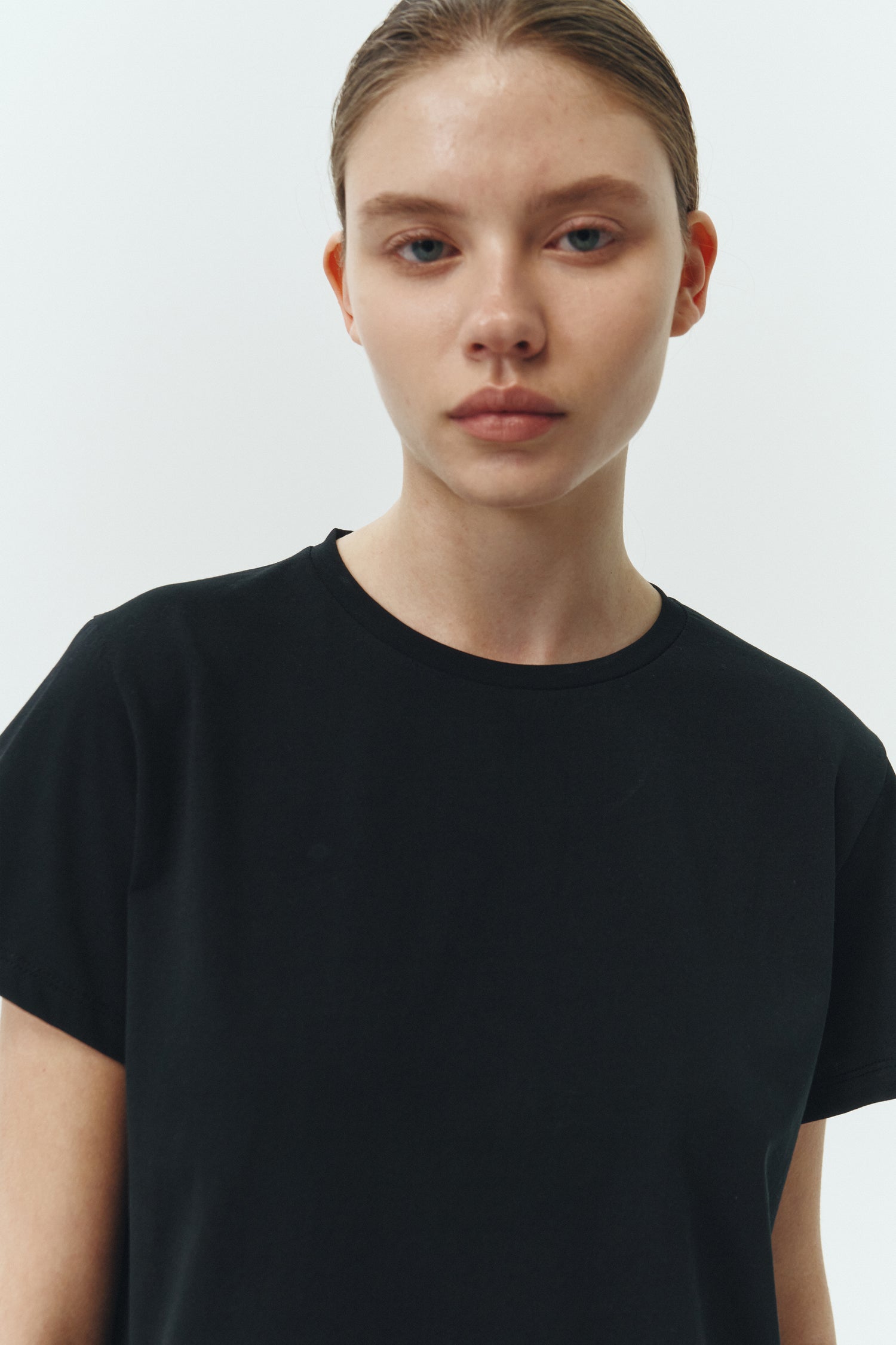 Ivy T-shirt in black, cropped short-sleeve tee in a lightweight cotton-poly blend with crew neck, regular fit, and clean silhouette.