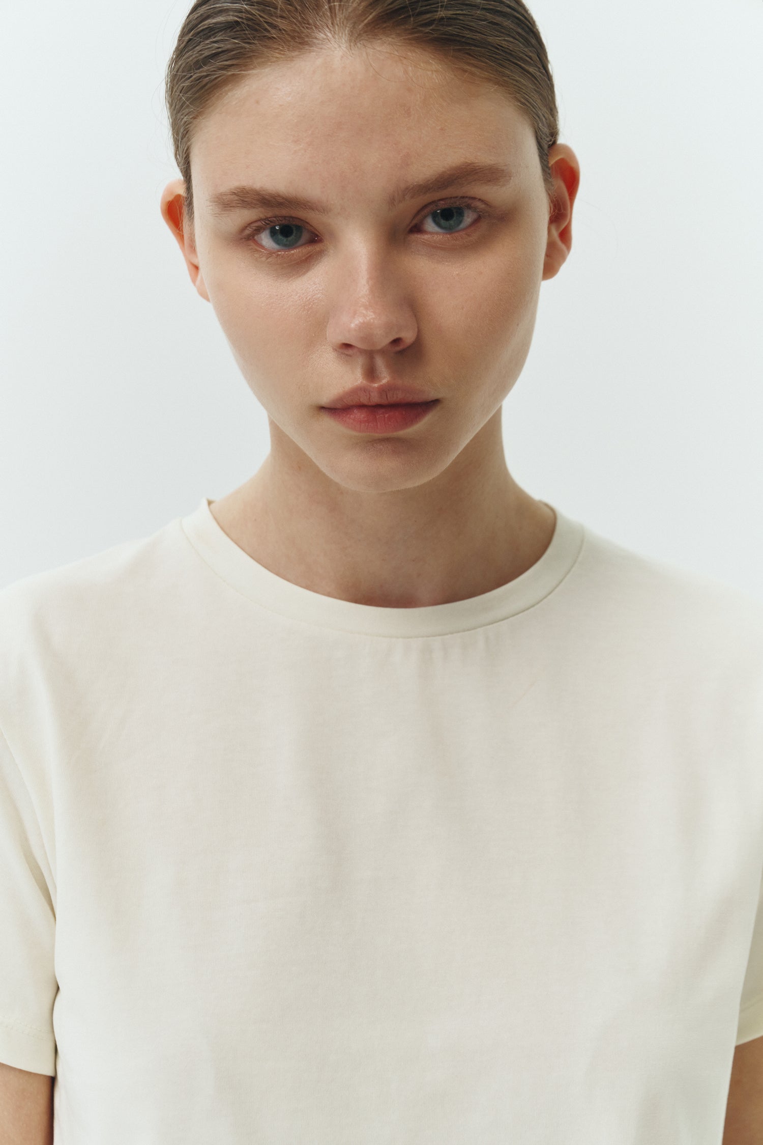 Ivy T-shirt in ivory, cropped short-sleeve tee in a lightweight cotton-poly blend with crew neck, regular fit, and clean silhouette.