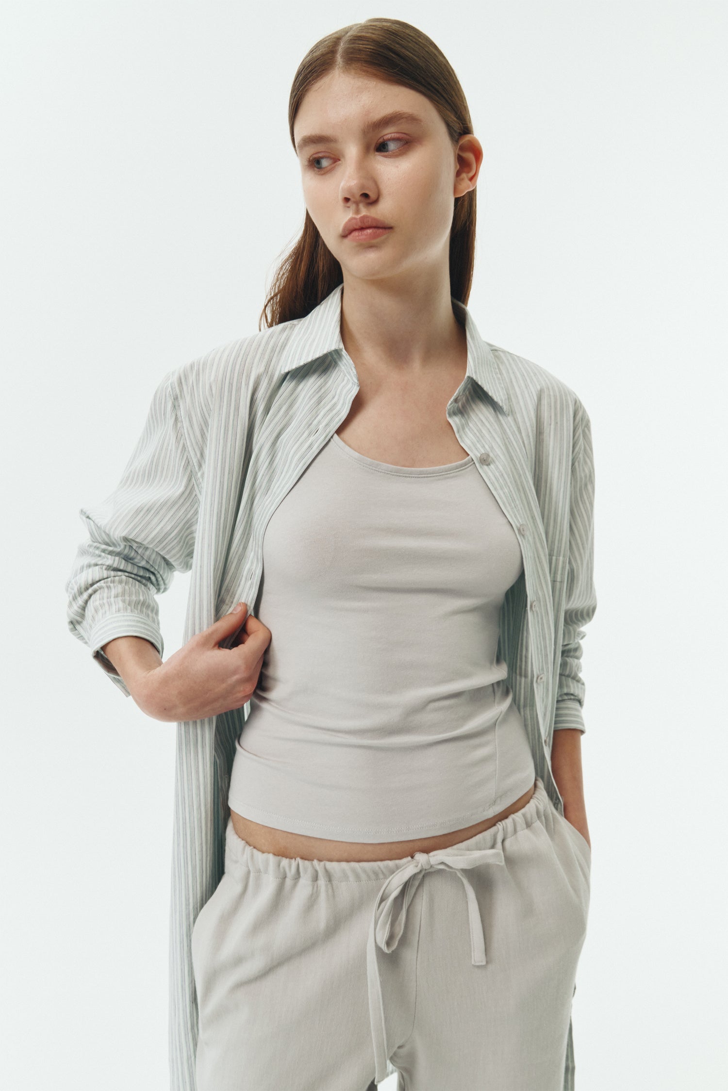 Zoe Tank Top in cloud gray, slim-fit stretch cotton tank with scooped neckline and diagonal seam detail for a sleek and minimal silhouette.