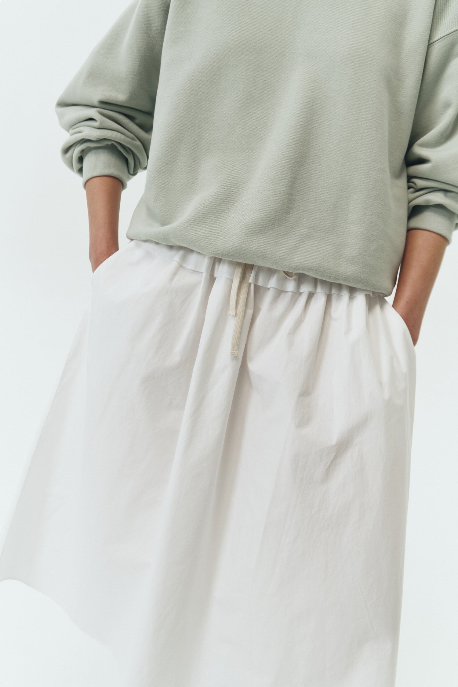 Maryam Skirt in sky, a midi cotton skirt with shirred waistband, drawstring detail, side pockets, and a softly flared silhouette