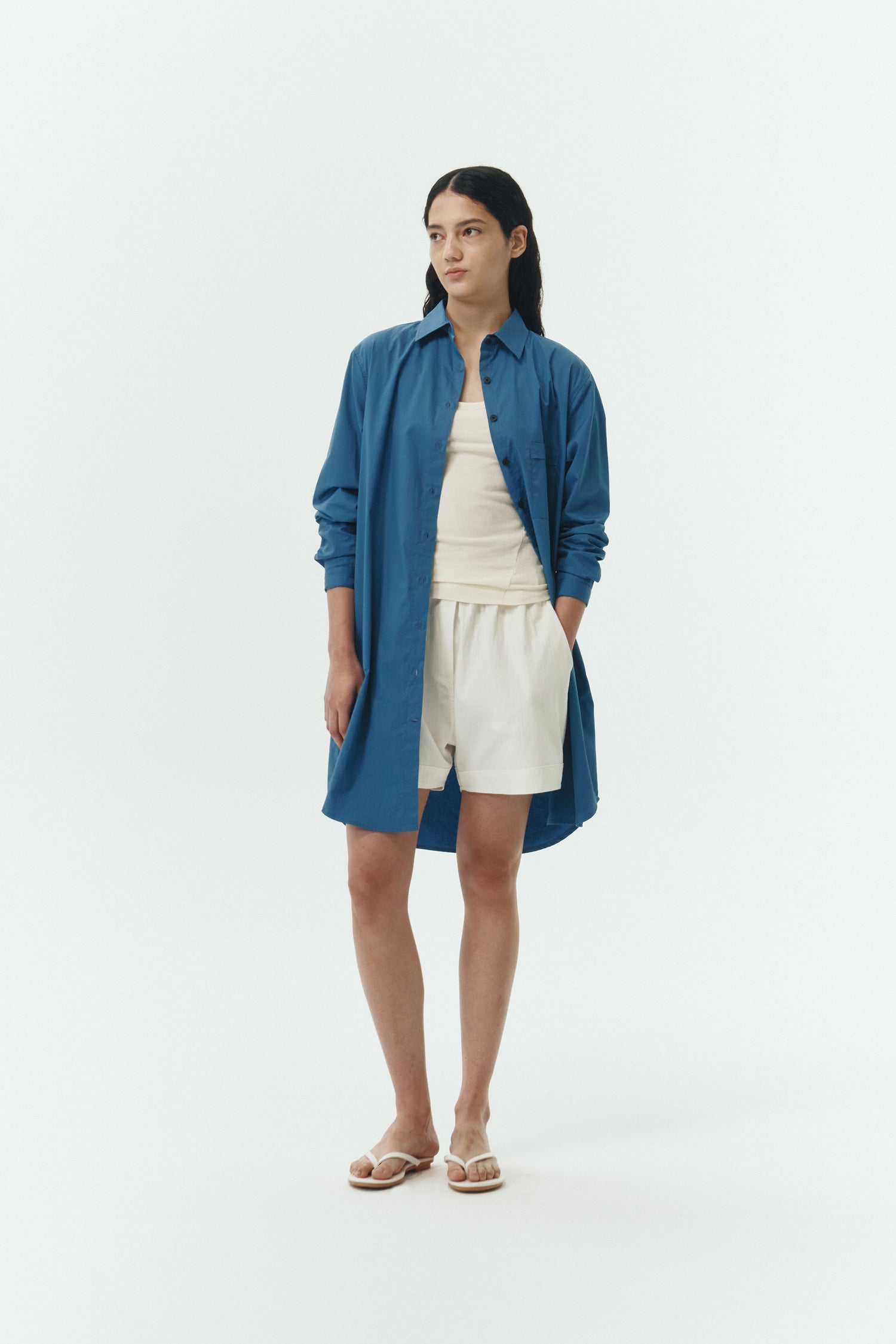 Cara Dress in blue green, long sleeve cotton shirt dress with front chest pocket, curved hem, hidden side pockets, and a relaxed silhouette.