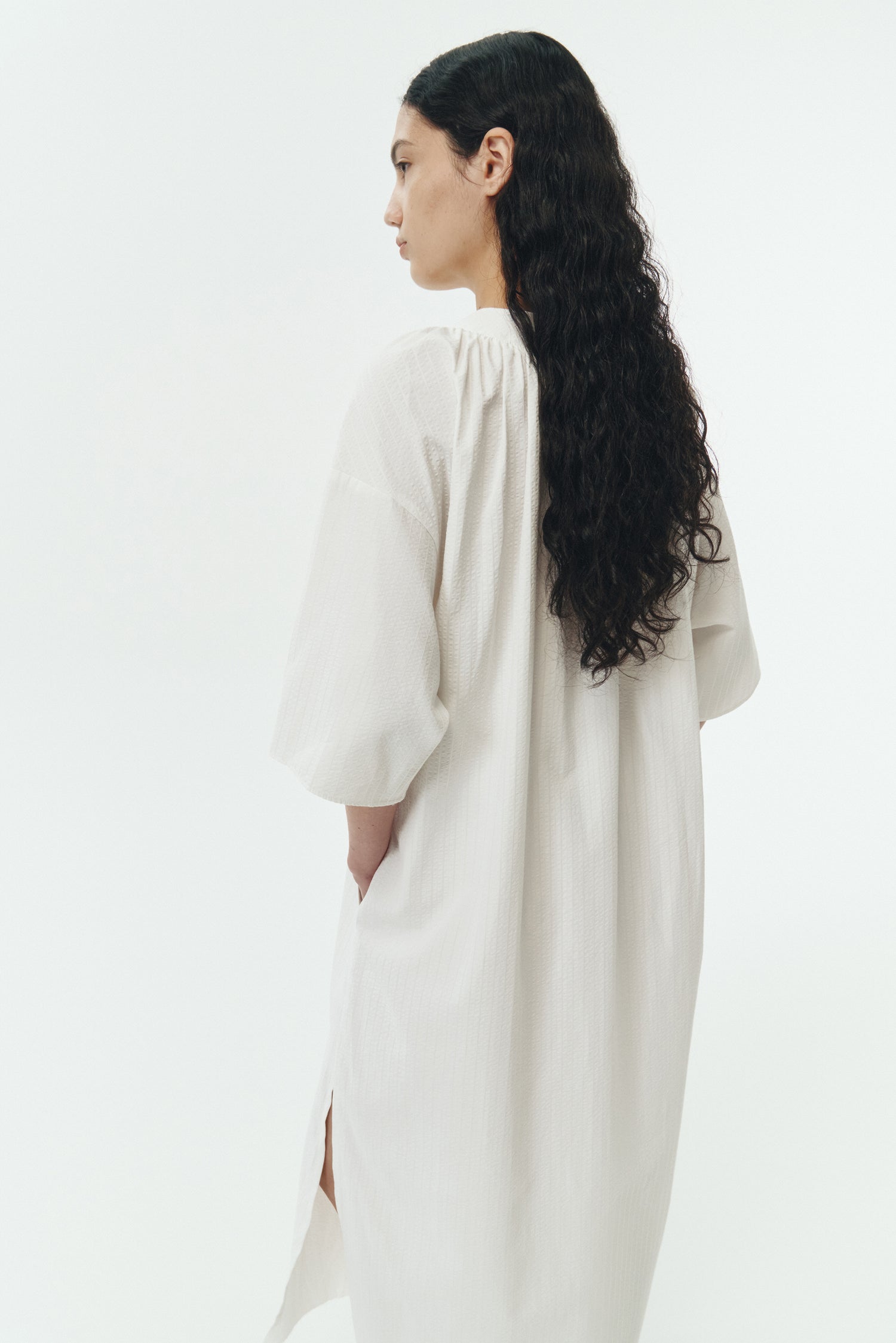 Charlotte Dress in white stripe, V-neck summer maxi dress in a lightweight linen-rayon blend with drop shoulders, hidden side pockets, raw edge hem, and a relaxed fit.