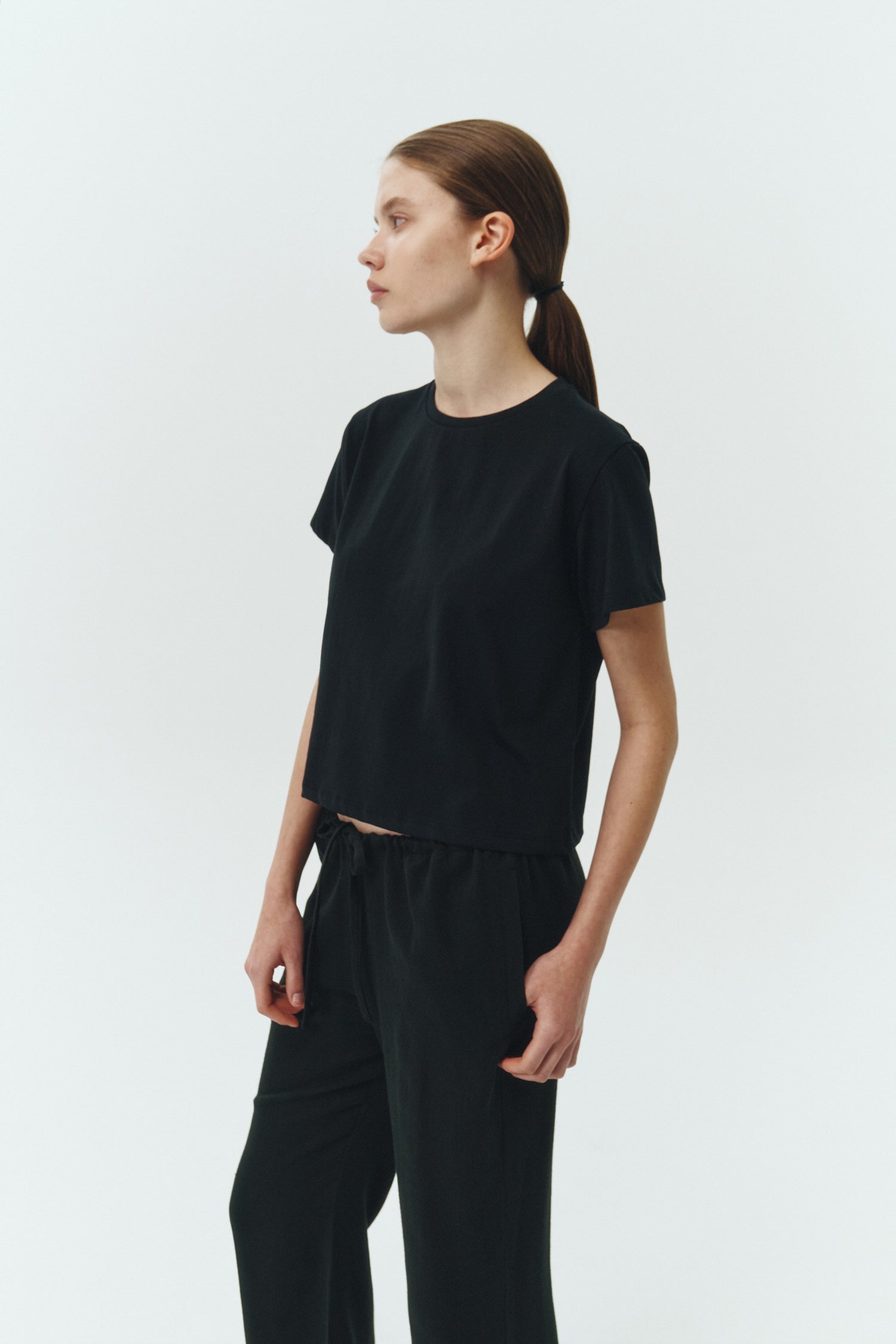 Ivy T-shirt in black, cropped short-sleeve tee in a lightweight cotton-poly blend with crew neck, regular fit, and clean silhouette.