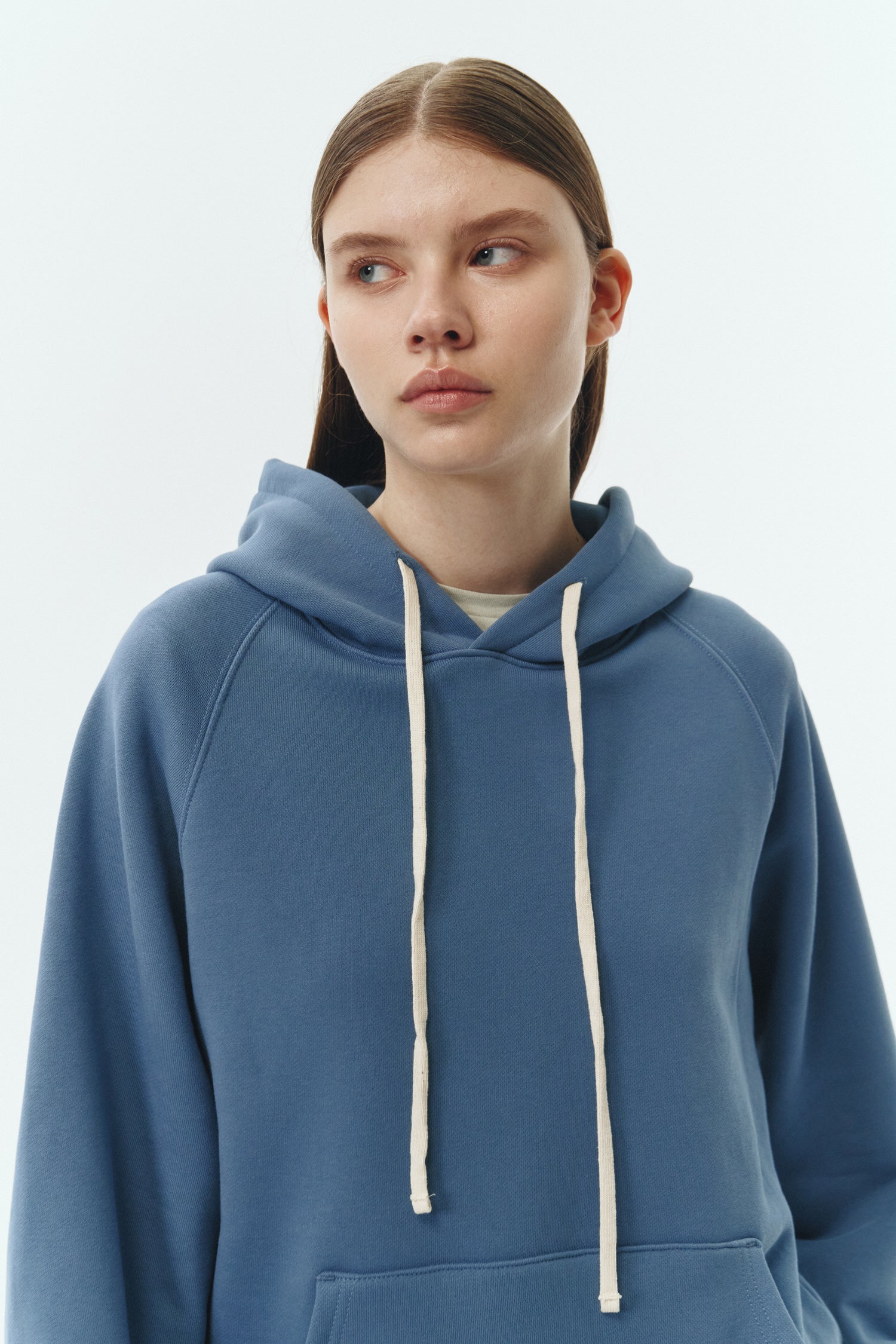 Kaia Hoodie in indigo blue, oversized cotton French terry pullover with drawstring hood, raglan sleeves, kangaroo pocket, and ribbed trims.