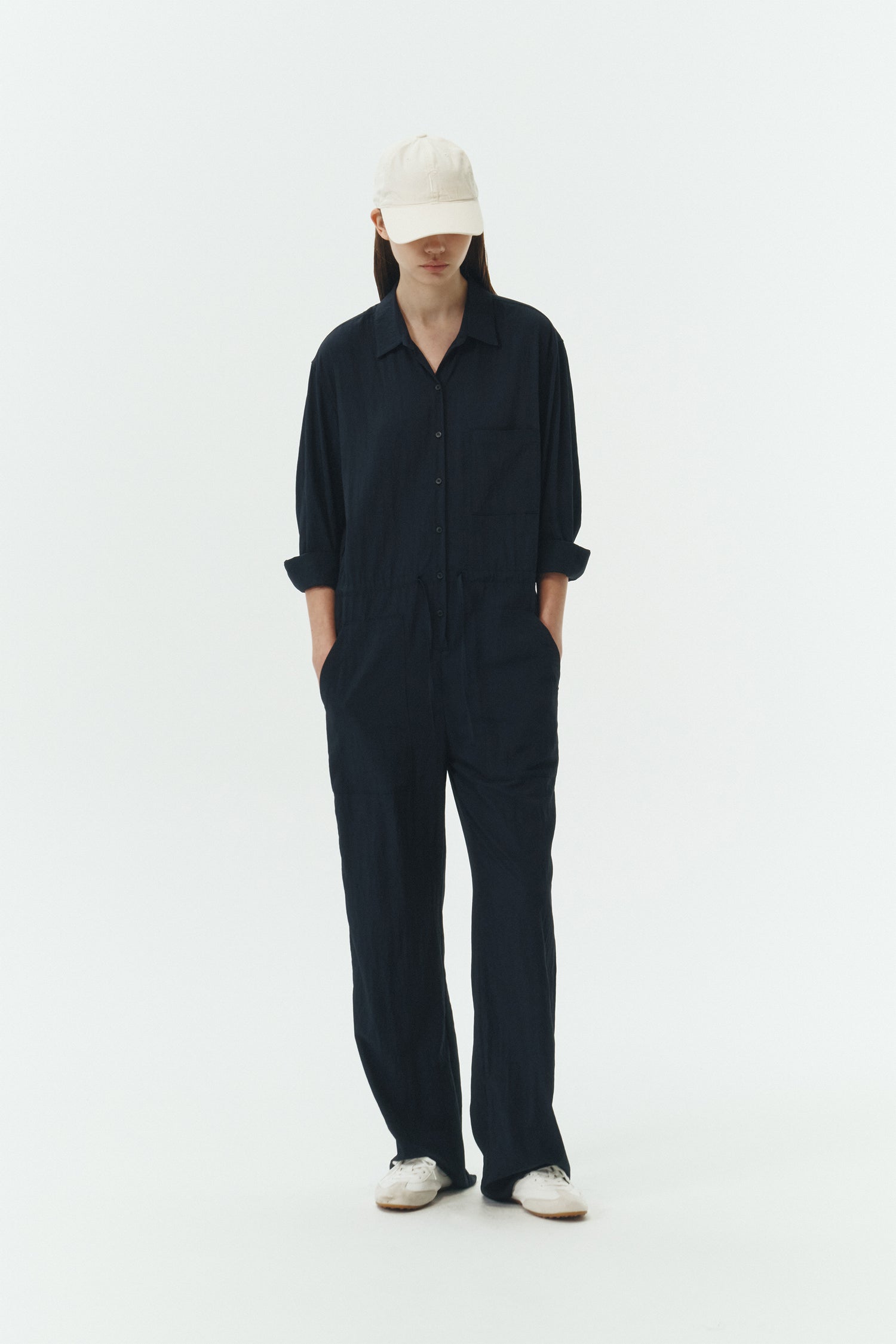 Saige Jumpsuit in navy, long-sleeve rayon blend jumpsuit with point collar, front button closure, drawstring waist, and patch pockets