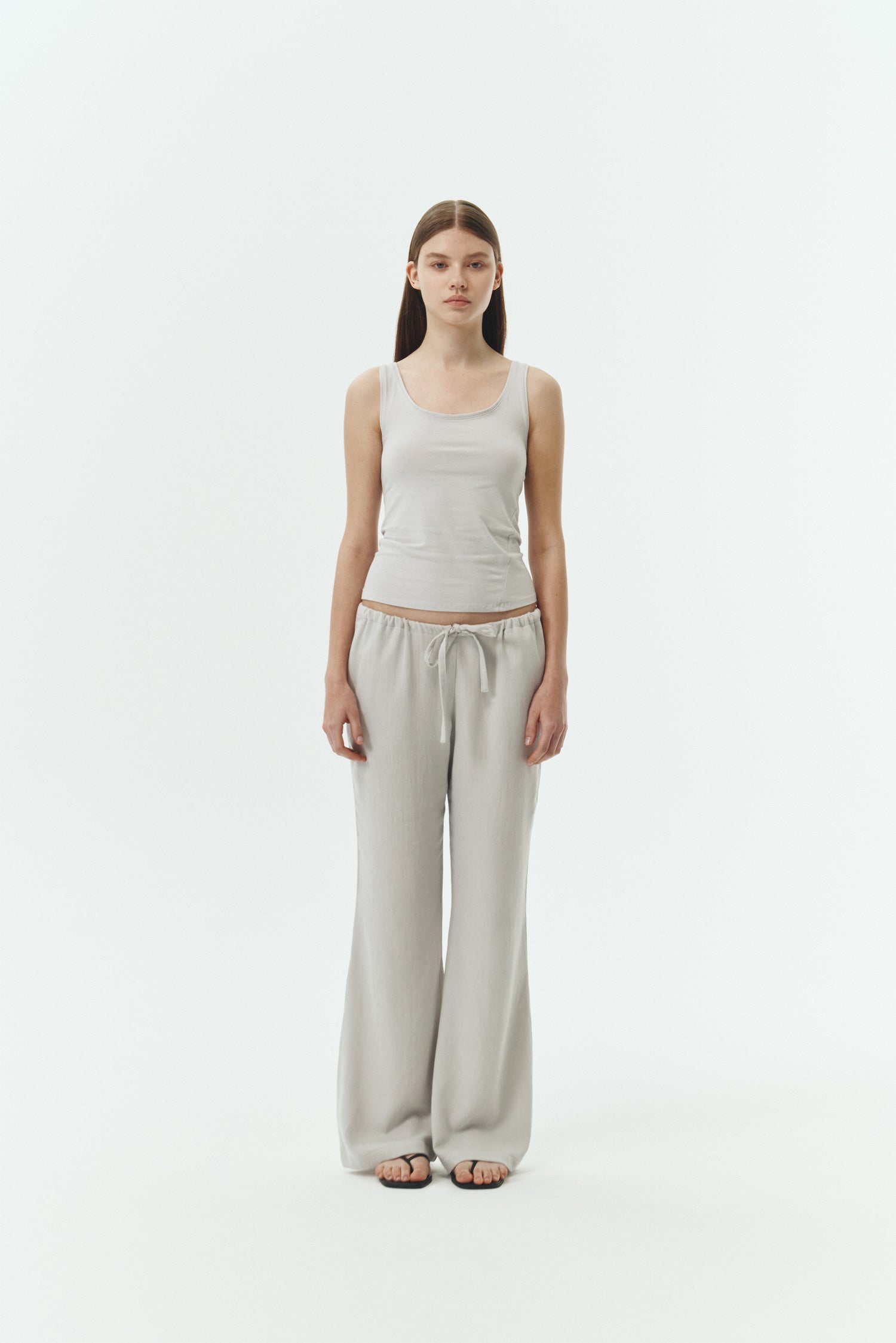 Zoe Tank Top in cloud gray, slim-fit stretch cotton tank with scooped neckline and diagonal seam detail for a sleek and minimal silhouette.