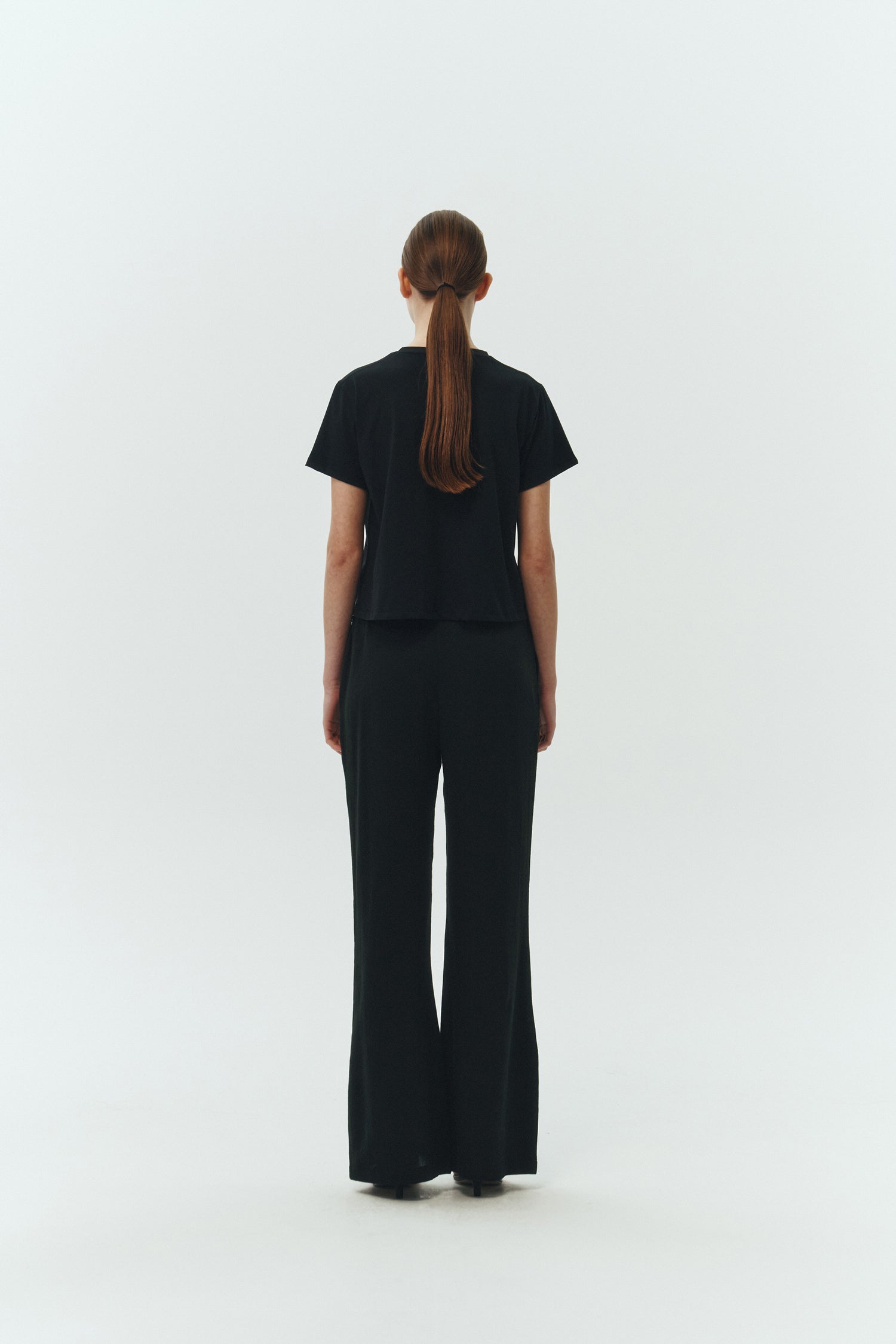 Chloe Pants in black, lightweight cotton pants with a drawstring waist, side pockets, and a flared bottom, relaxed fit for effortless everyday wear