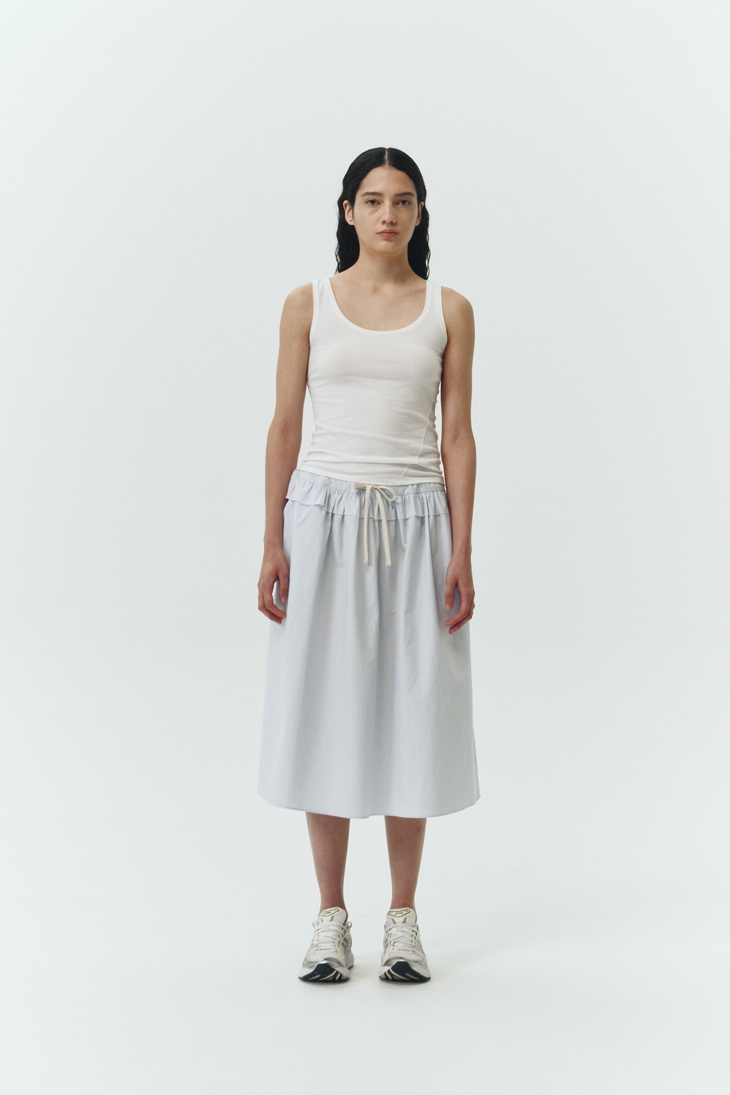 Maryam Skirt in sky, a midi cotton skirt with shirred waistband, drawstring detail, side pockets, and a softly flared silhouette