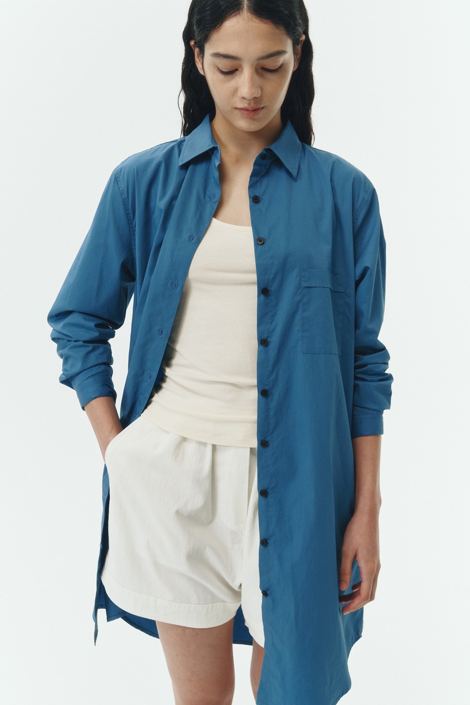 Cara Dress in blue green, long sleeve cotton shirt dress with front chest pocket, curved hem, hidden side pockets, and a relaxed silhouette.