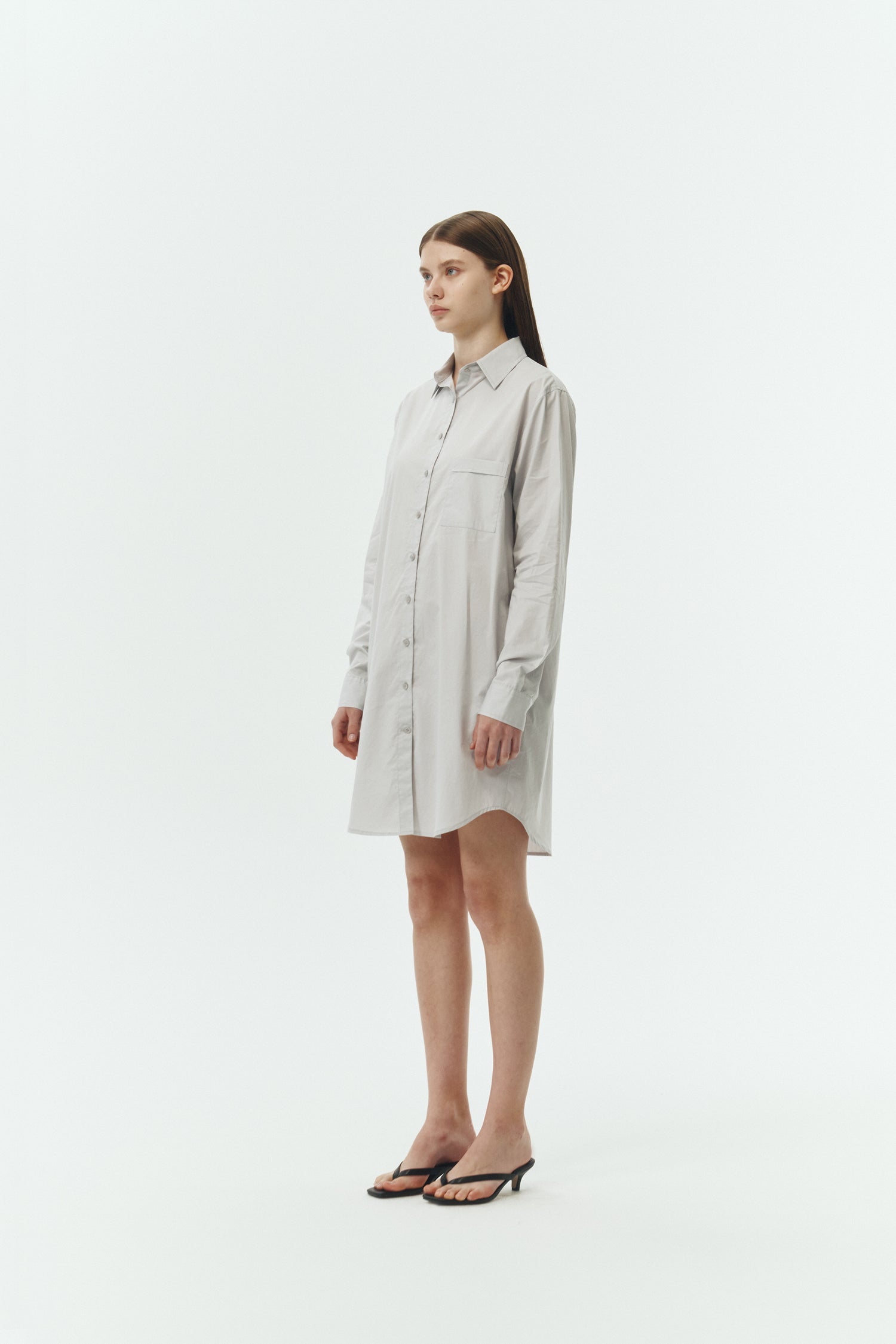 Cara Dress in cloud gray, long sleeve cotton shirt dress with front chest pocket, curved hem, hidden side pockets, and a relaxed silhouette.