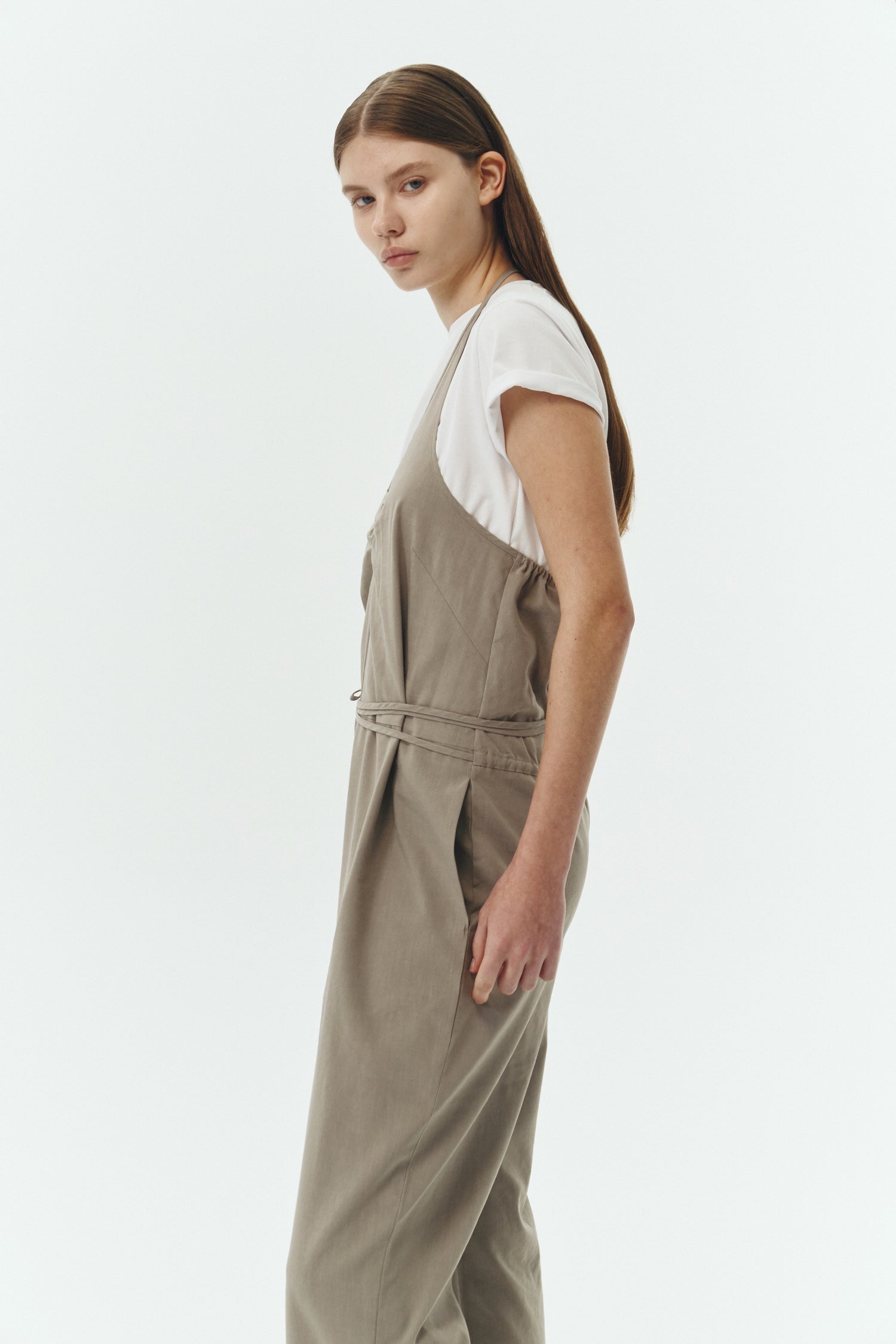 Daisy Jumpsuit in khaki gray, sleeveless linen blend jumpsuit with adjustable halterneck, open back, straight-leg silhouette, and relaxed fit.