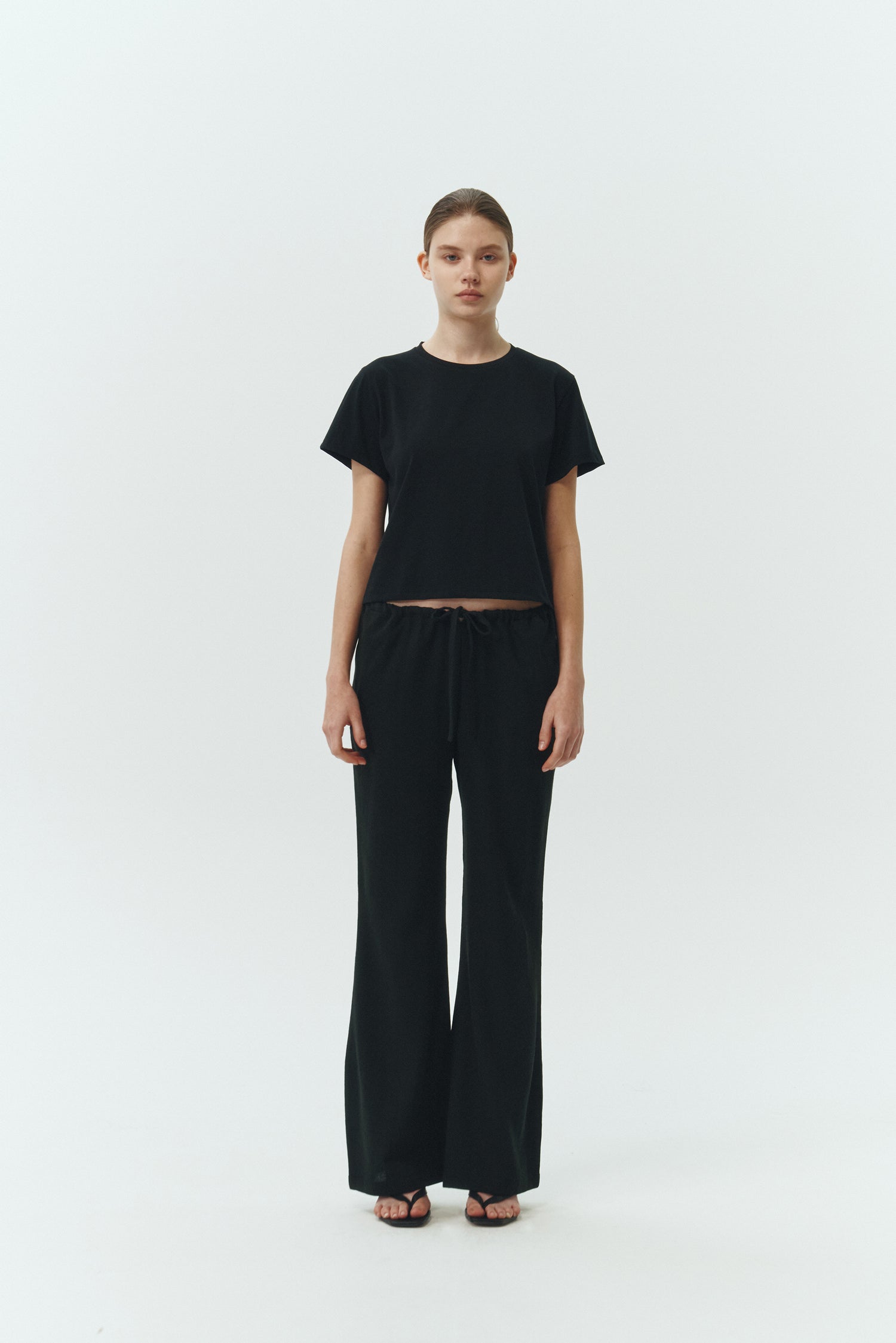 Ivy T-shirt in black, cropped short-sleeve tee in a lightweight cotton-poly blend with crew neck, regular fit, and clean silhouette.