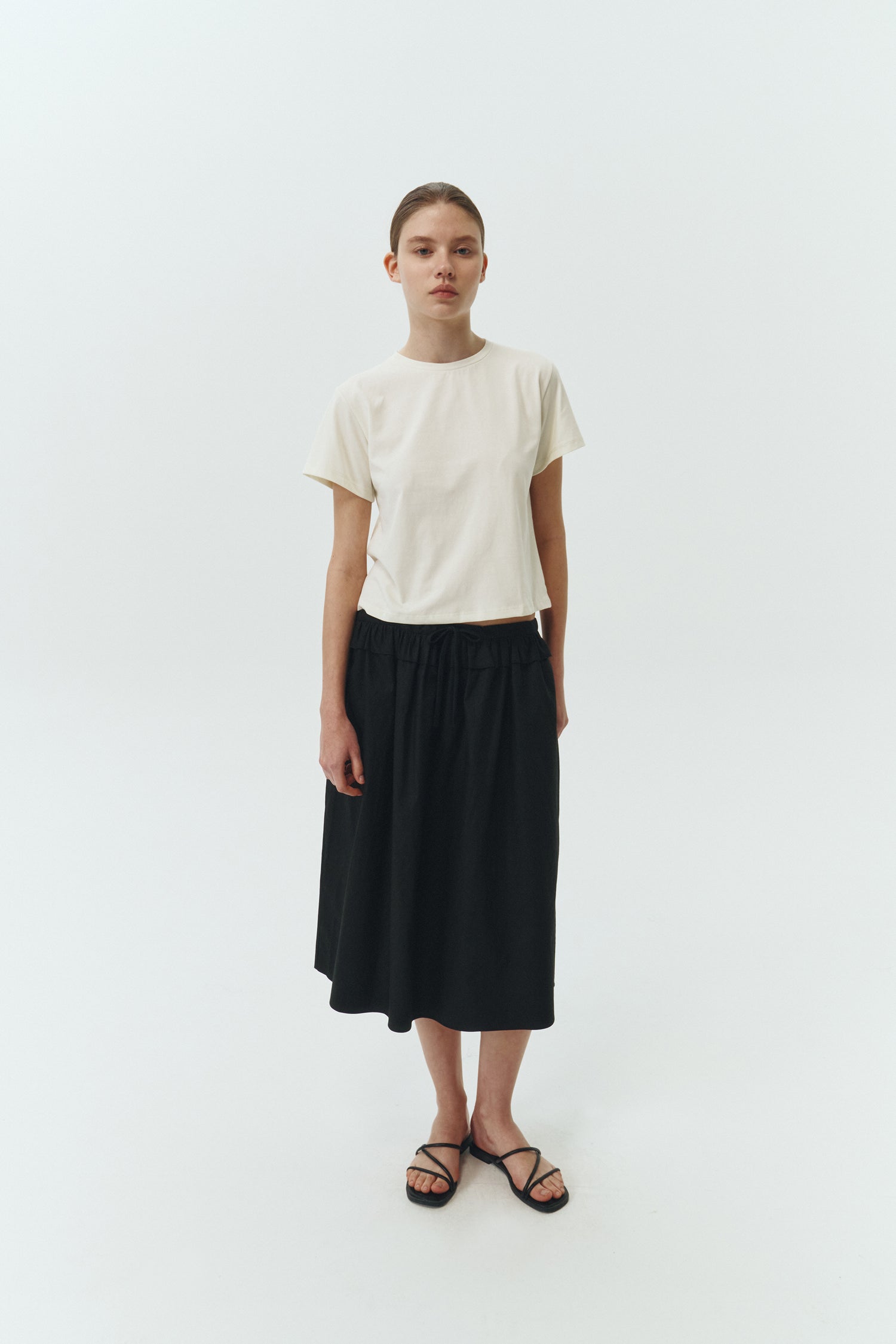 Ivy T-shirt in ivory, cropped short-sleeve tee in a lightweight cotton-poly blend with crew neck, regular fit, and clean silhouette.