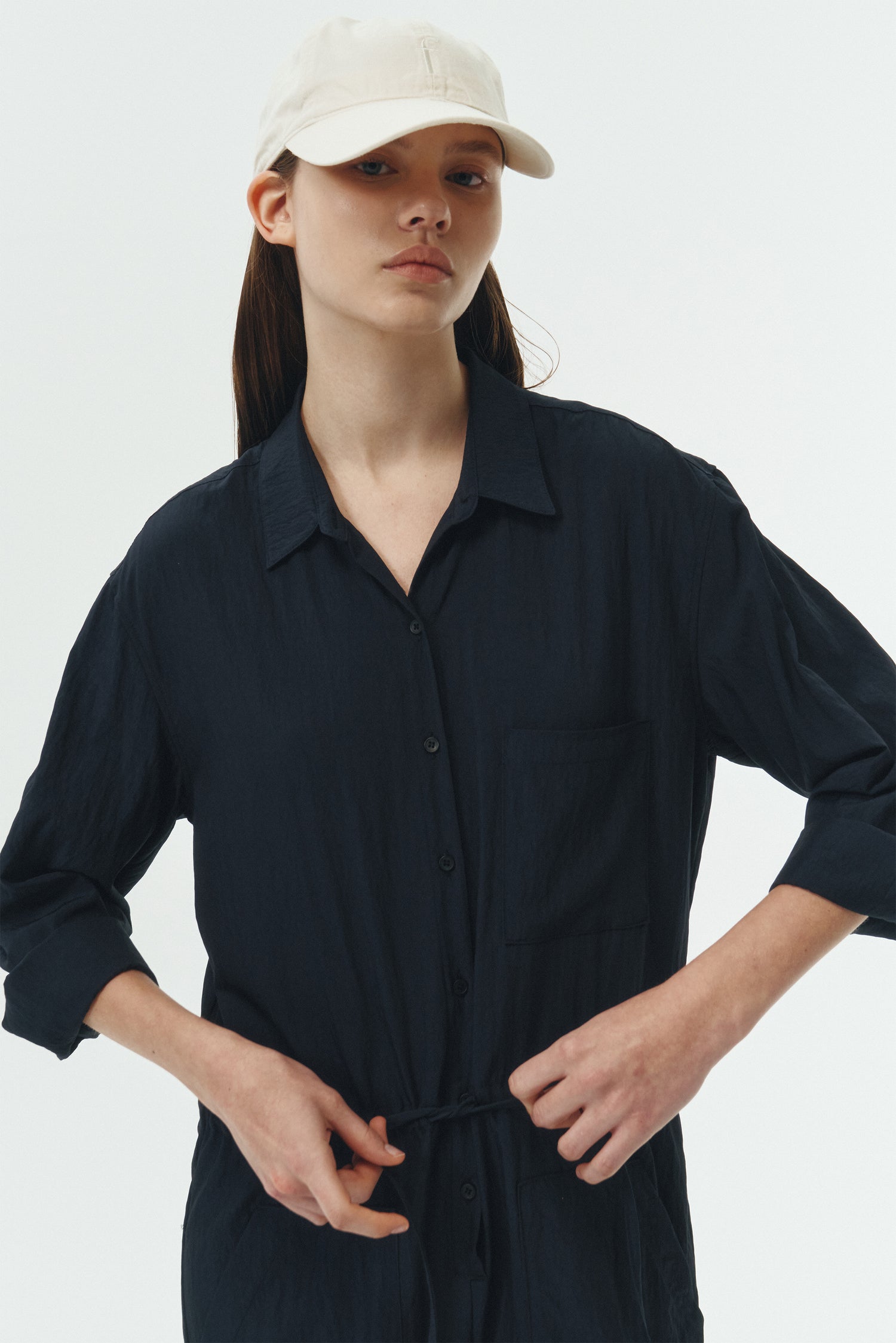 Saige Jumpsuit in navy, long-sleeve rayon blend jumpsuit with point collar, front button closure, drawstring waist, and patch pockets