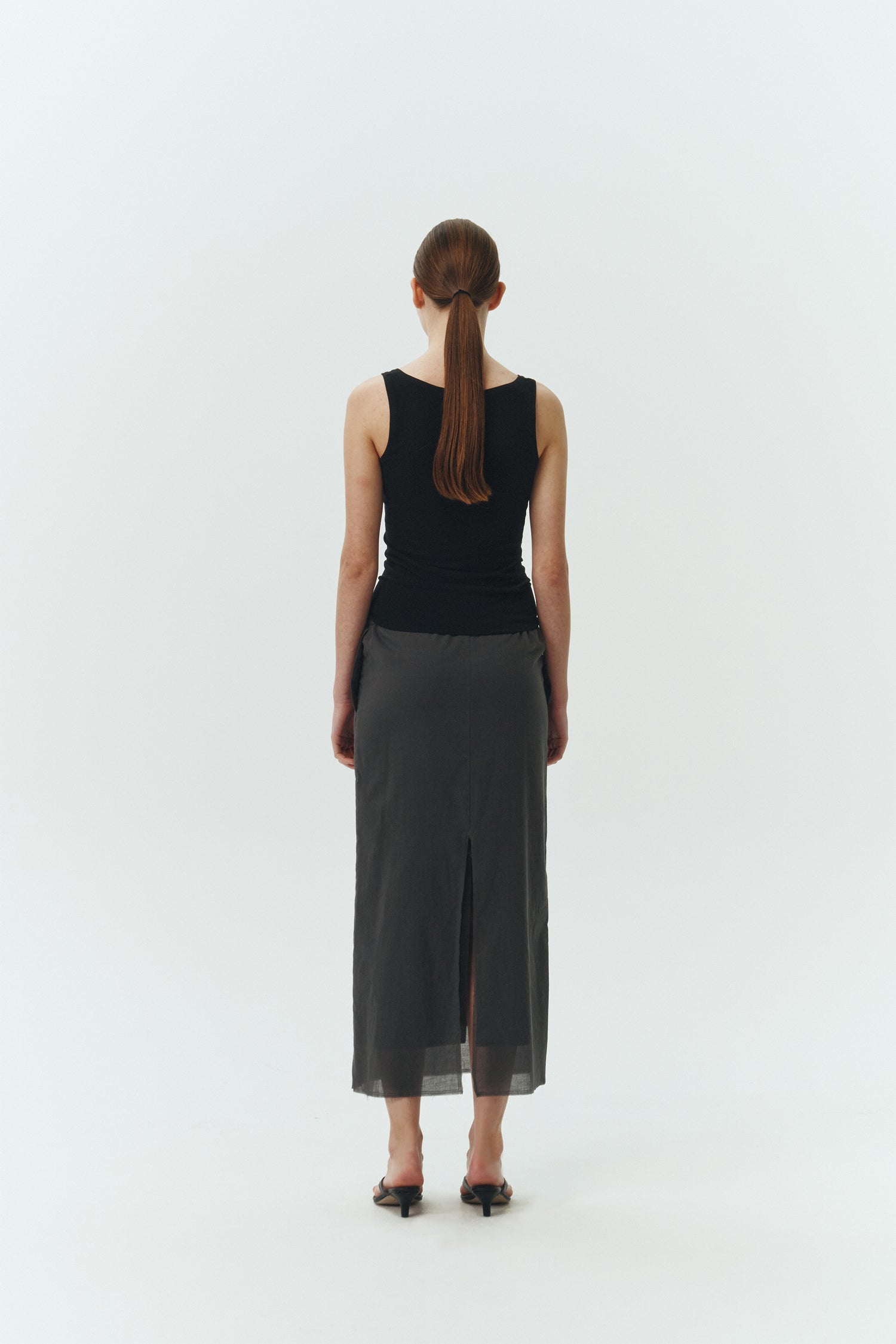 Zoe Tank Top in black, slim-fit stretch cotton tank with scooped neckline and diagonal seam detail for a sleek and minimal silhouette.