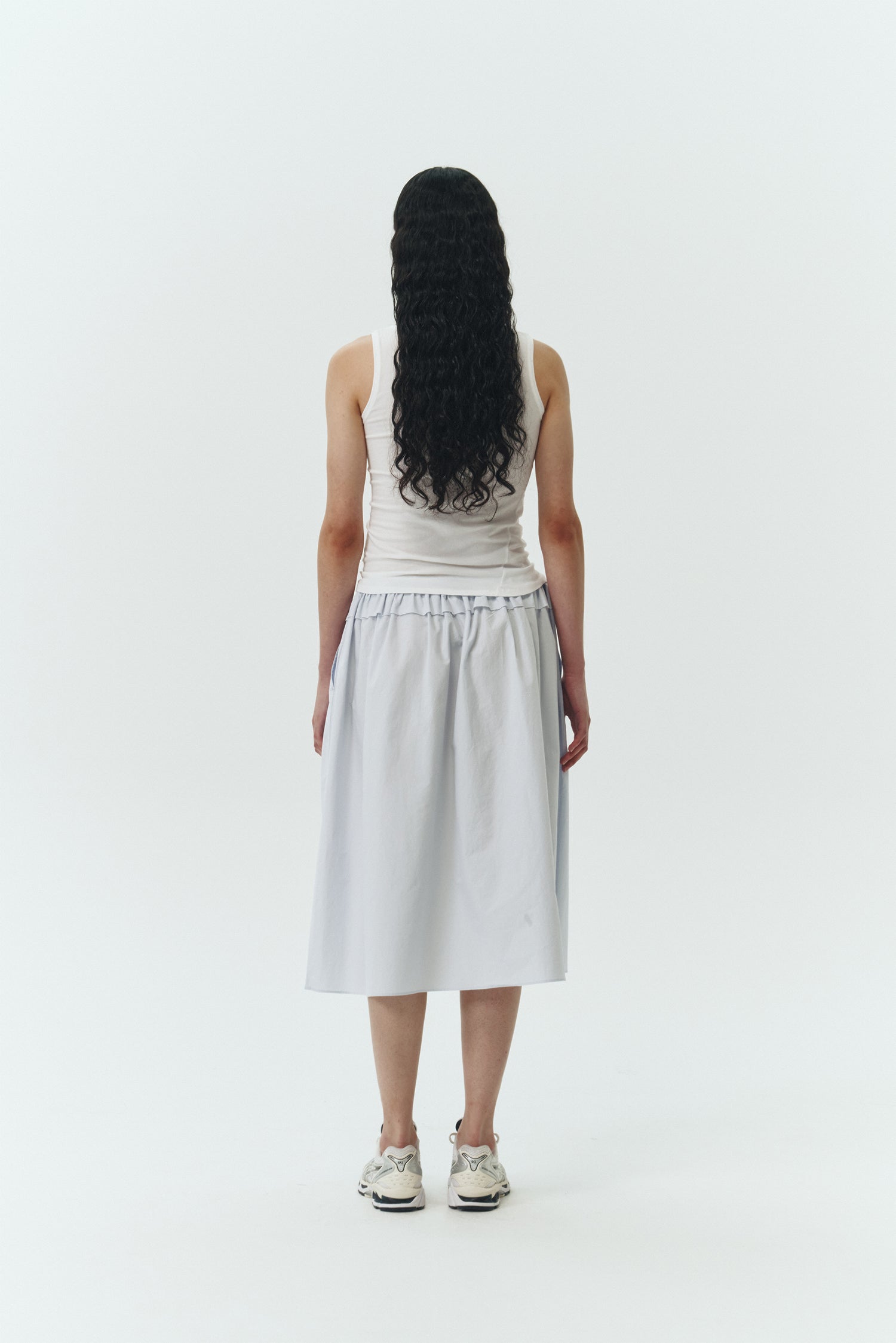 Zoe Tank Top in white, slim-fit stretch cotton tank with scooped neckline and diagonal seam detail for a sleek and minimal silhouette.