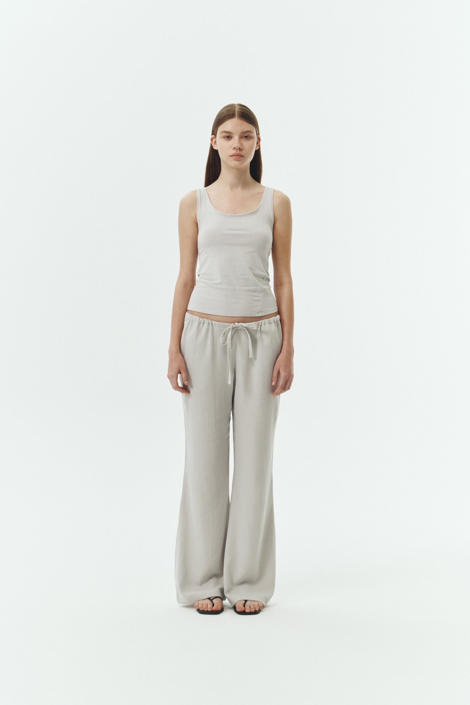 Chloe Pants in cloud gray, lightweight cotton pants with a drawstring waist, side pockets, and a flared bottom, relaxed fit for effortless everyday wear
