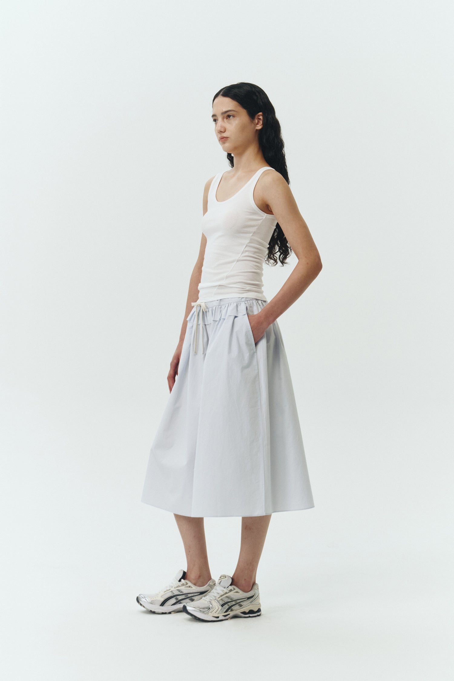 Maryam Skirt in sky, a midi cotton skirt with shirred waistband, drawstring detail, side pockets, and a softly flared silhouette