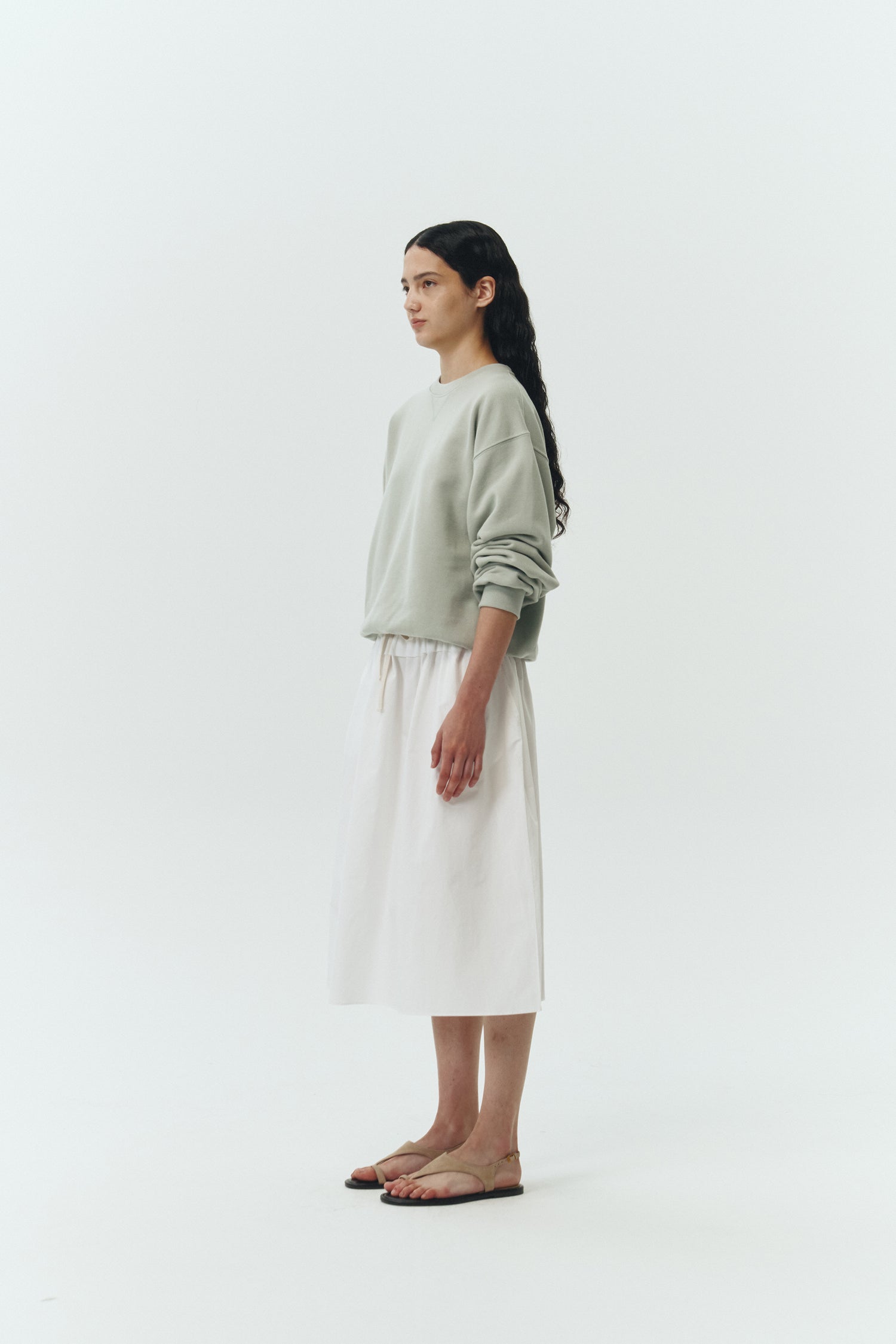 Maryam Skirt in sky, a midi cotton skirt with shirred waistband, drawstring detail, side pockets, and a softly flared silhouette