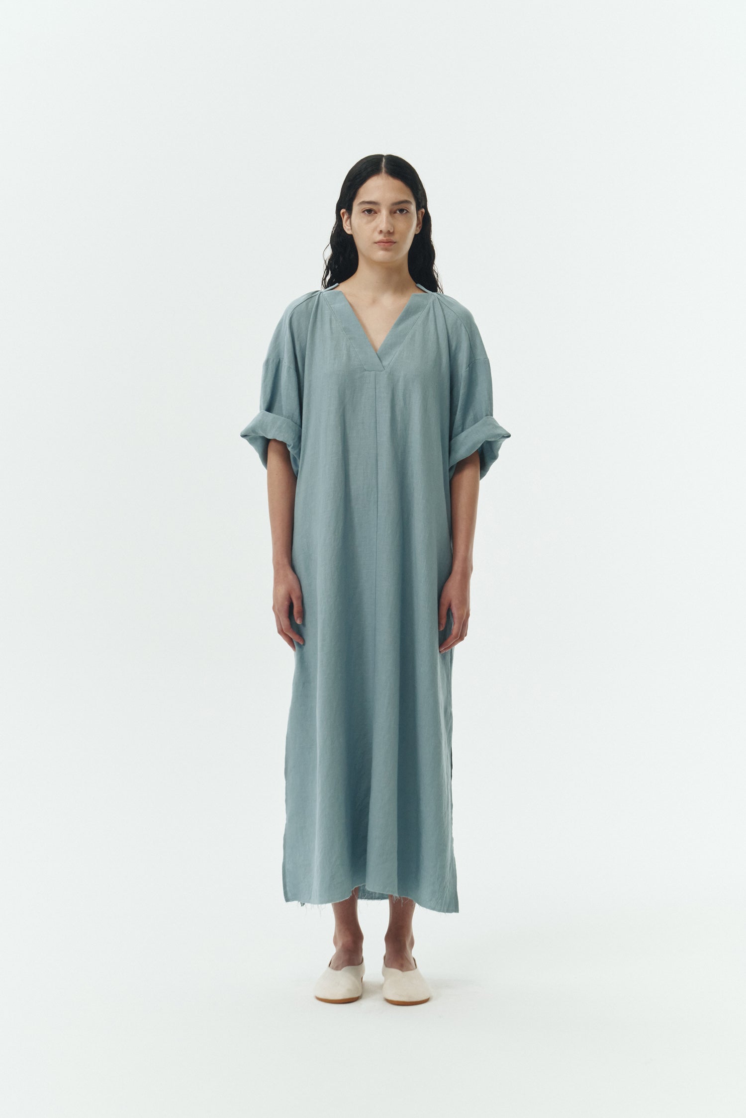 Charlotte Dress in light blue, V-neck summer maxi dress in a lightweight linen-rayon blend with drop shoulders, hidden side pockets, raw edge hem, and a relaxed fit.