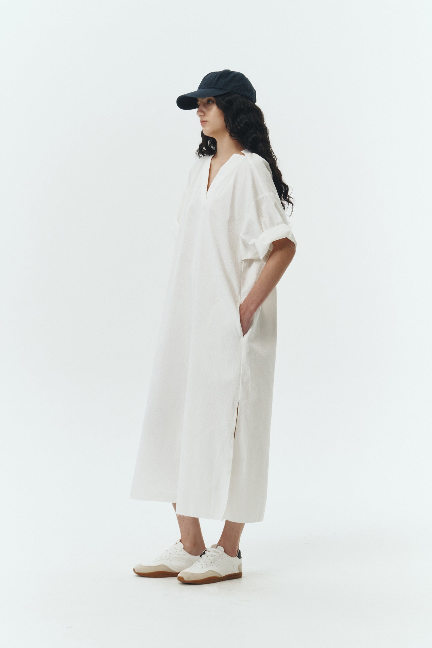 Charlotte Dress in white stripe, V-neck summer maxi dress in a lightweight linen-rayon blend with drop shoulders, hidden side pockets, raw edge hem, and a relaxed fit.