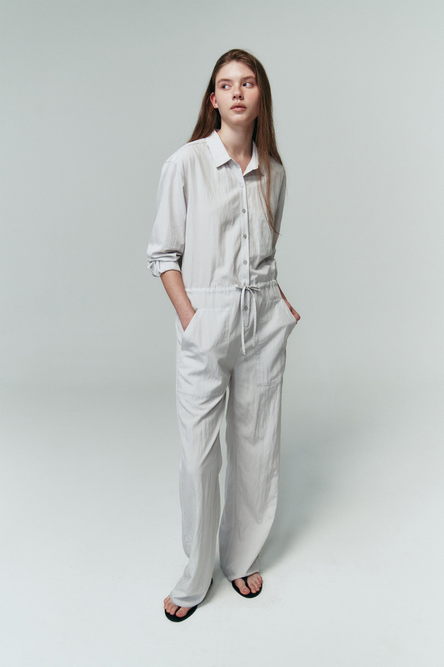 Saige Jumpsuit in cloud, long-sleeve rayon blend jumpsuit with point collar, front button closure, drawstring waist, and patch pockets.