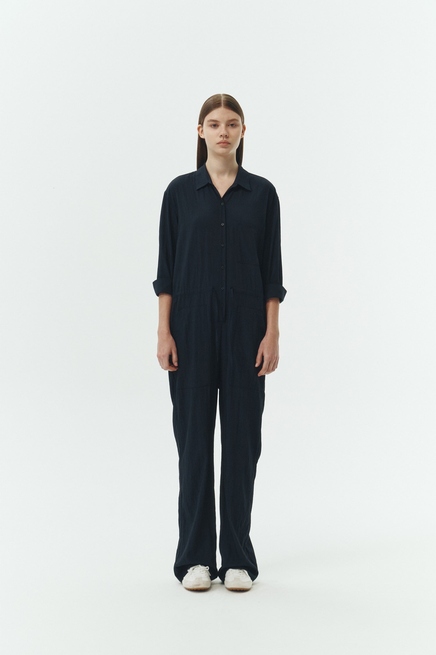 Saige Jumpsuit in navy, long-sleeve rayon blend jumpsuit with point collar, front button closure, drawstring waist, and patch pockets