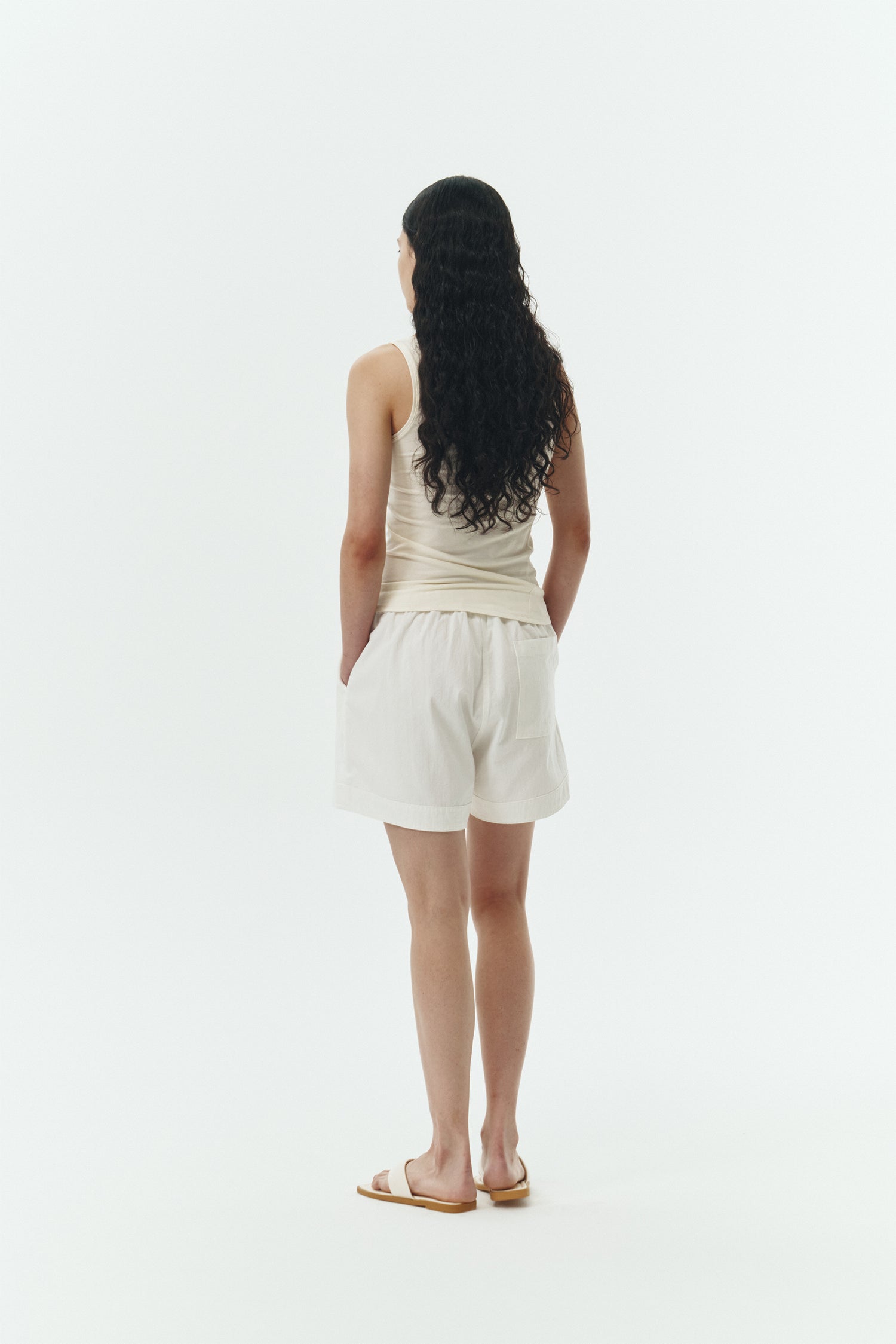 Zoe Tank Top in cream, slim-fit stretch cotton tank with scooped neckline and diagonal seam detail for a sleek and minimal silhouette.