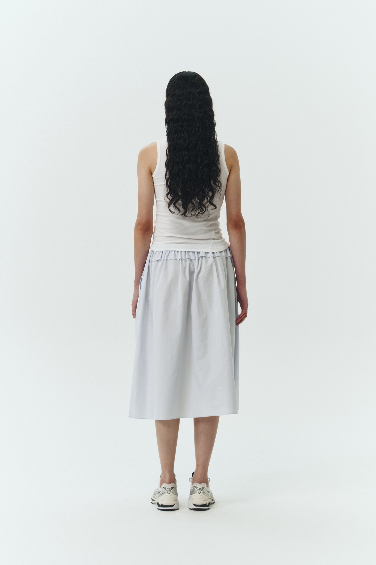 Maryam Skirt in sky, a midi cotton skirt with shirred waistband, drawstring detail, side pockets, and a softly flared silhouette