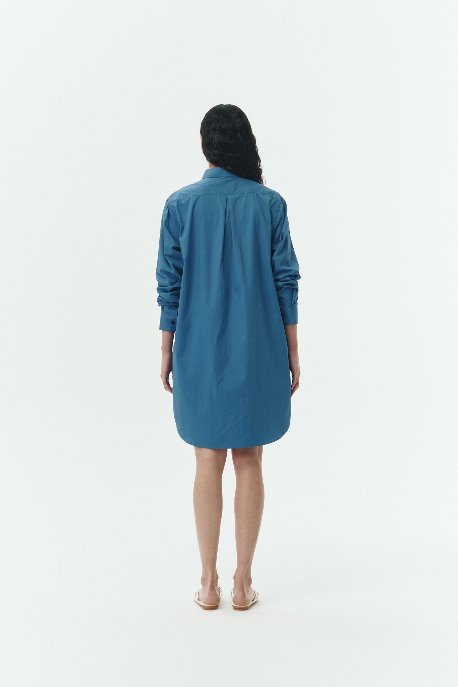 Cara Dress in blue green, long sleeve cotton shirt dress with front chest pocket, curved hem, hidden side pockets, and a relaxed silhouette.