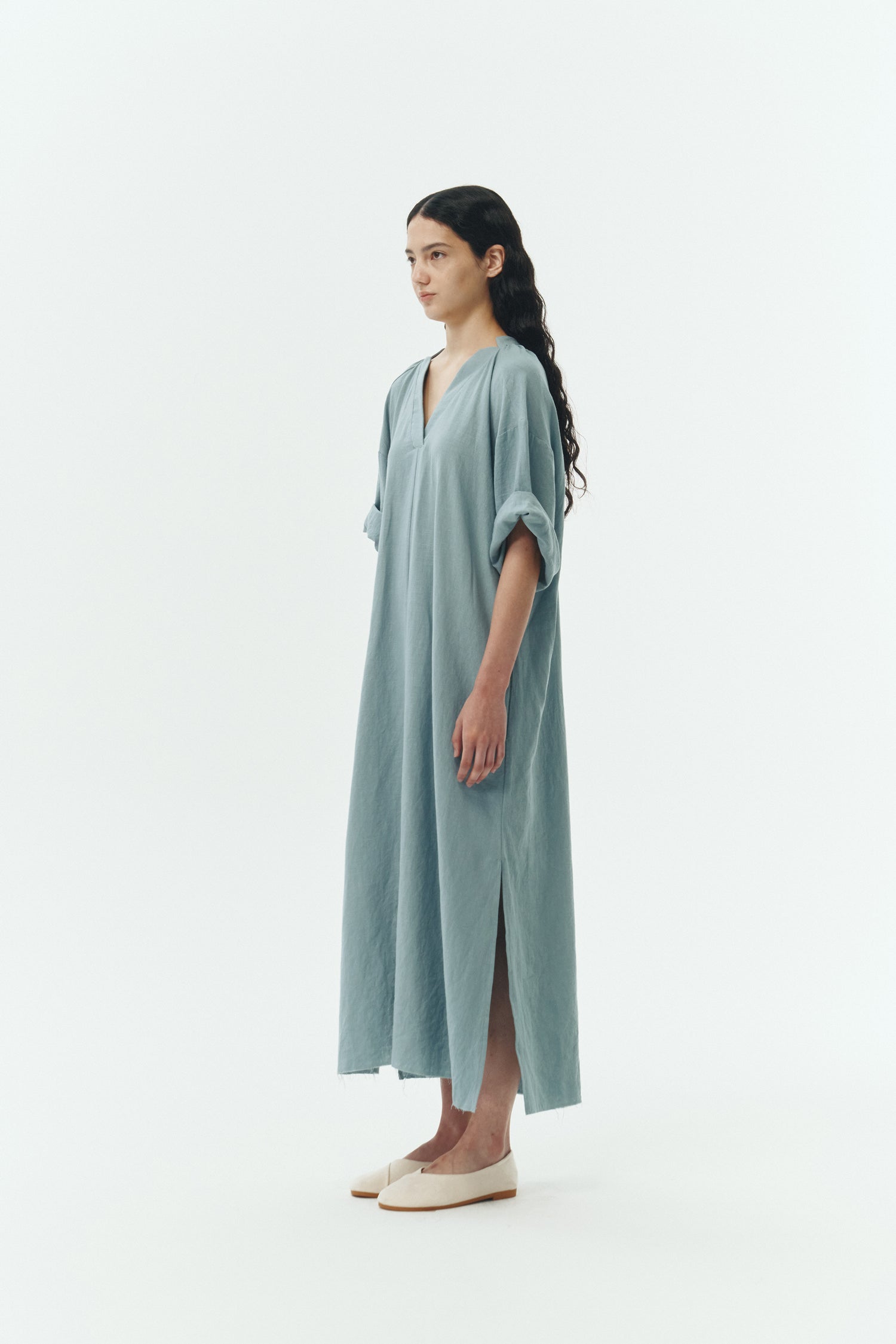 Charlotte Dress in light blue, V-neck summer maxi dress in a lightweight linen-rayon blend with drop shoulders, hidden side pockets, raw edge hem, and a relaxed fit.